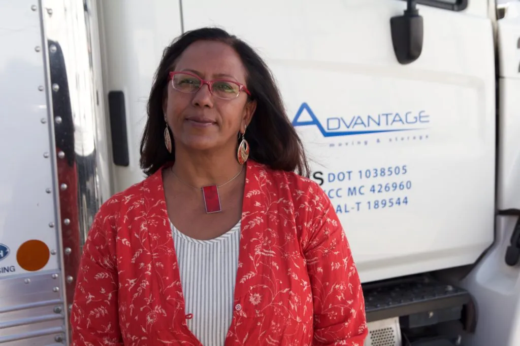 Picture of  A poised individual stands beside an Advantage Moving & Storage truck, embodying the company's focus on quality outcomes. Their presence reflects a commitment that has earned them Diamond Certified. Copyright ©2025 Diamond Certified Resource.

 - Advantage Moving & Storage