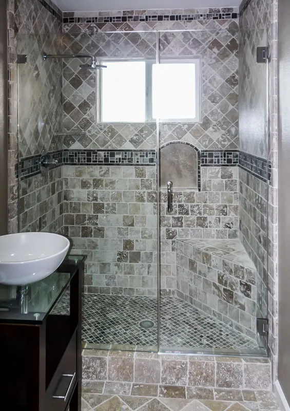Picture of  A beautifully crafted stone-tiled shower, featuring a sleek glass door and subtle geometric patterns, highlights Schicker Luxury Shower Doors, Inc.'s dedication to quality outcomes. Recognized for expertise and quality, they transform bathrooms into elegant retreats. Copyright ©2025 Diamond Certified Resource.

 - Schicker Luxury Shower Doors, Inc.