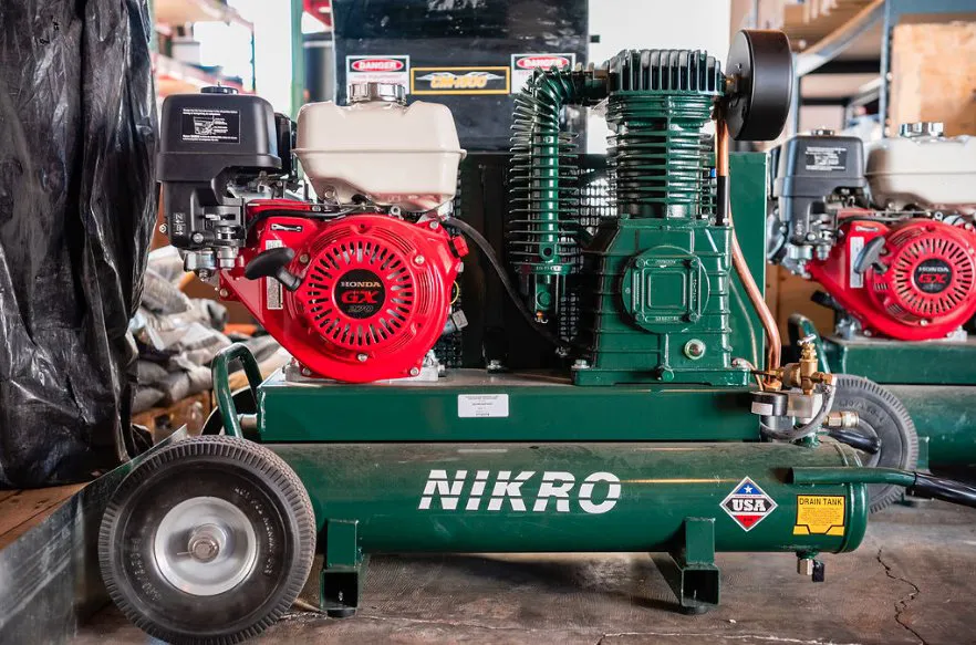 Picture of In the heart of Alley Cat's workshop, a Nikro air compressor stands ready for action. Known for its commitment to quality outcomes, Alley Cat employs such tools to ensure precision and efficiency in every project. Copyright ©2025 Diamond Certified Resource

 - Alley Cat