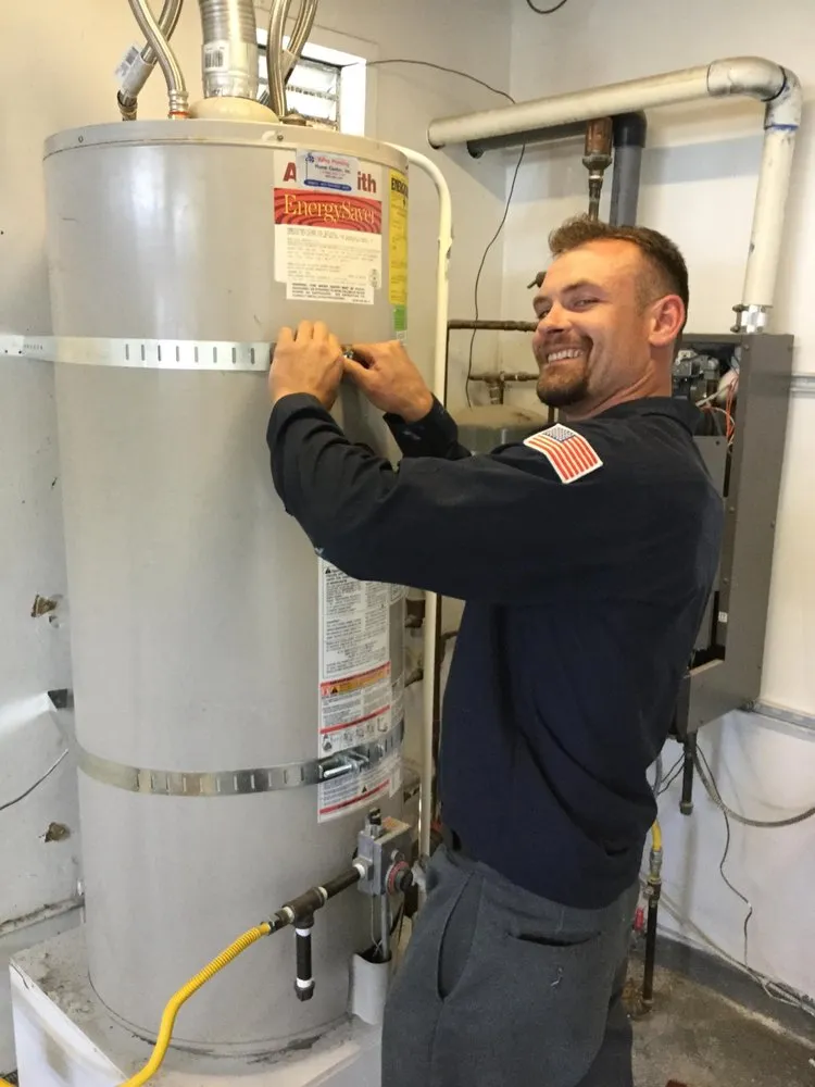 Picture of A technician from Big Blue Plumbing expertly secures a water heater, embodying the company's focus on quality outcomes. Their consistent dedication ensures top-rated service for every client. Copyright ©2025 Diamond Certified Resource - Big Blue Plumbing