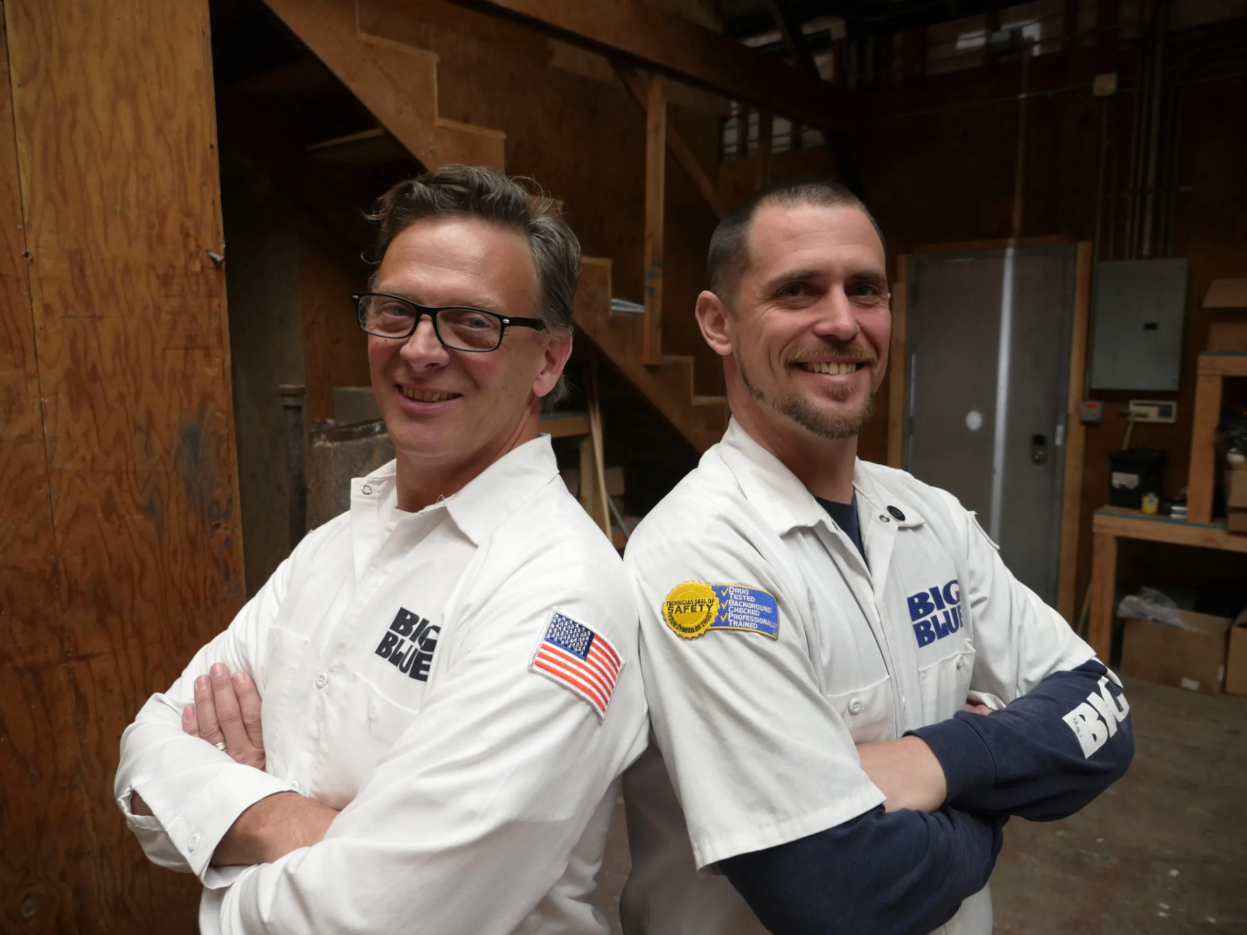 Picture of Two team members of Big Blue Plumbing stand confidently back-to-back, embodying the companyâ€™s commitment to quality outcomes. Big Blue Plumbing focuses on providing top-rated services, evident in their proud demeanor and shared expertise. Copyright ©2025 Diamond Certified Resource

 - Big Blue Plumbing