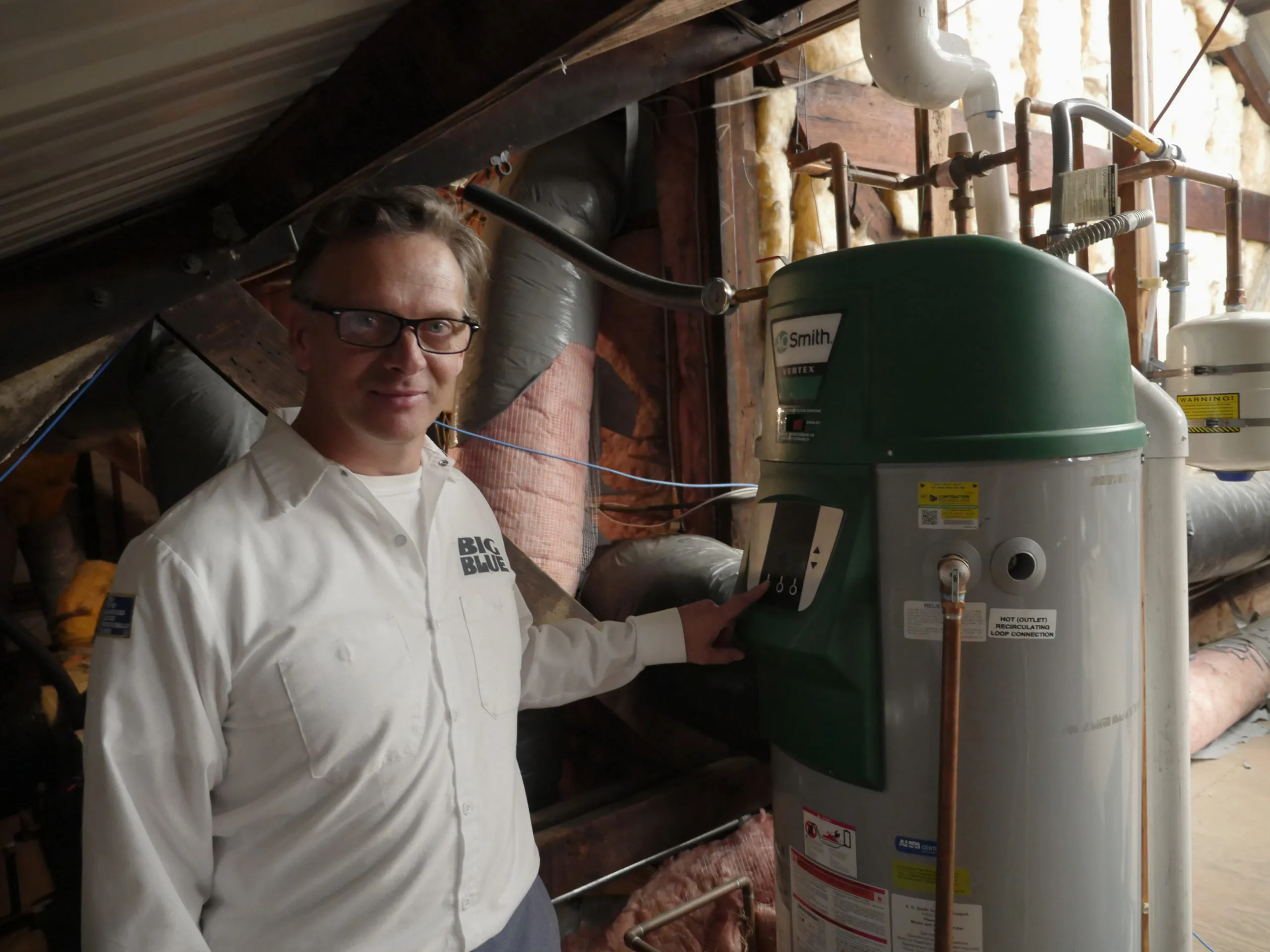 Picture of In a dimly lit attic, a technician from Big Blue Plumbing adjusts a water heater with precision, embodying the company's commitment to quality outcomes. With a focus on expert installation and maintenance, Big Blue Plumbing ensures your home systems are in top condition. Copyright ©2025 Diamond Certified Resource

 - Big Blue Plumbing
