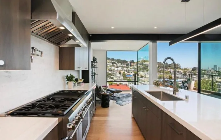 Picture of In a masterpiece of modern design, AMS Construction creates a seamless blend of indoor luxury and outdoor splendor with this open kitchen concept. The companyâ€™s focus on quality outcomes is evident in the use of premium materials and meticulous craftsmanship. Copyright ©2025 Diamond Certified Resource - AMS Construction