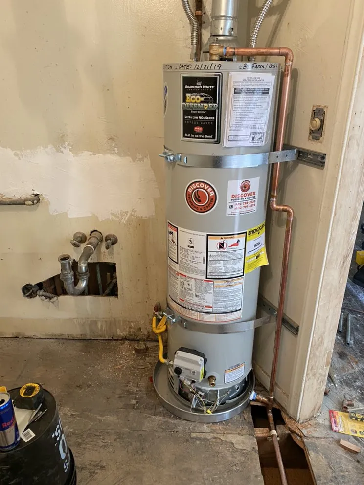Picture of In a corner of a room, a newly installed water heater stands as a testament to Discover Plumbing & Rooter's commitment to quality outcomes. The meticulous work, evidenced by the precise piping, highlights their Diamond Certified expertise. Copyright ©2025 Diamond Certified Resource

 - Discover Plumbing & Rooter