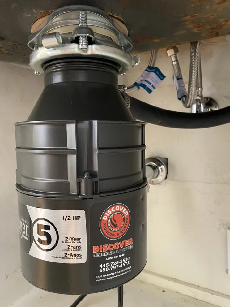 Picture of Beneath the kitchen sink, a newly installed garbage disposal hints at Discover Plumbing & Rooter's commitment to quality outcomes. The sleek device, backed by expertise, exemplifies their Diamond Certified focus. Copyright ©2025 Diamond Certified Resource

 - Discover Plumbing & Rooter