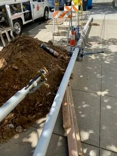 Picture of A trenchless pipe installation underway on a sunlit sidewalk illustrates Discover Plumbing & Rooter's commitment to quality outcomes. The orderly setup and precise equipment placement reflect their status for high customer satisfaction ratings. Copyright ©2025 Diamond Certified Resource - Discover Plumbing & Rooter
