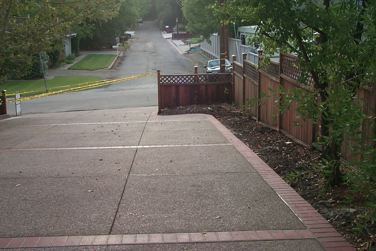 Picture of  A carefully crafted concrete driveway by Paradigm Concrete & Construction, Inc. leads to a calm, tree-lined street, reflecting the company's commitment to quality outcomes. Copyright ©2025 Diamond Certified Resource.

 - Paradigm Concrete & Construction, Inc.