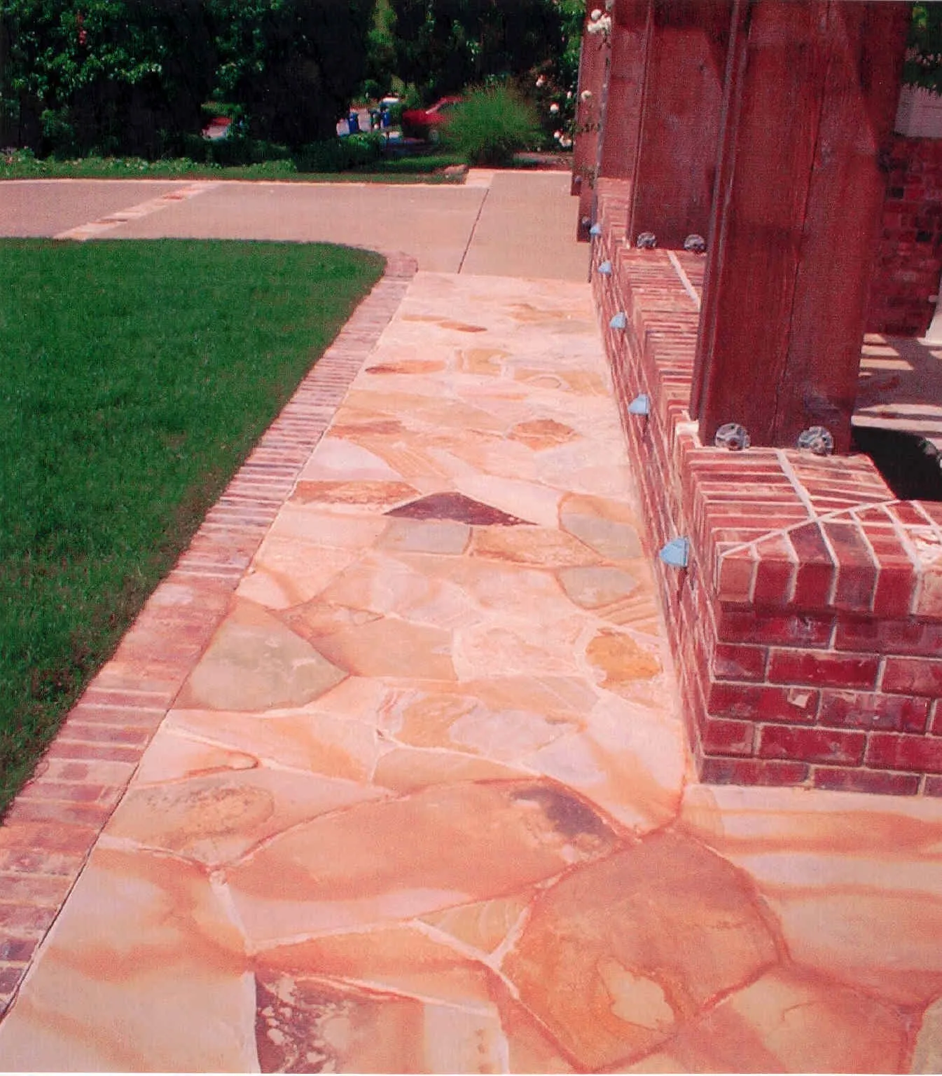 Picture of  Sunlit stone and brickwork blend seamlessly in this exterior walkway crafted by Paradigm Concrete & Construction, Inc., showcasing their commitment to quality outcomes. Copyright ©2025 Diamond Certified Resource.

 - Paradigm Concrete & Construction, Inc.