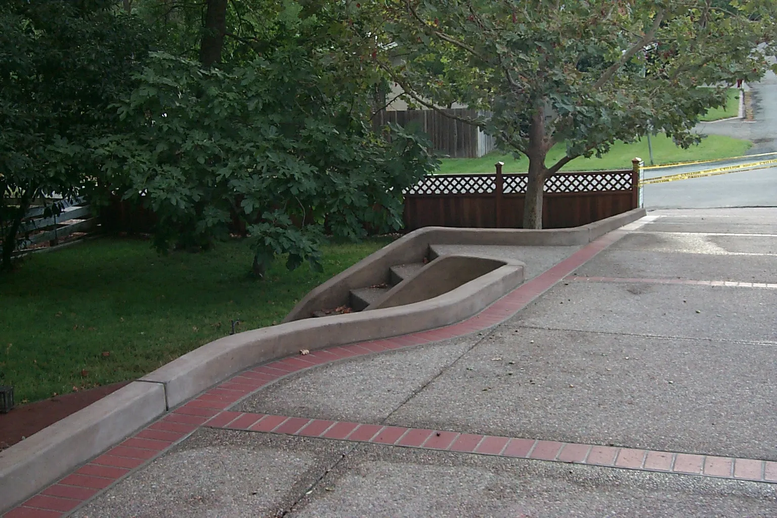 Picture of A gracefully curved concrete structure integrates seamlessly with the surrounding landscape, reflecting Paradigm Concrete & Construction, Inc.'s dedication to quality outcomes. This artful blend of design and functionality showcases their expertise. Copyright ©2025 Diamond Certified Resource. - Paradigm Concrete & Construction, Inc.