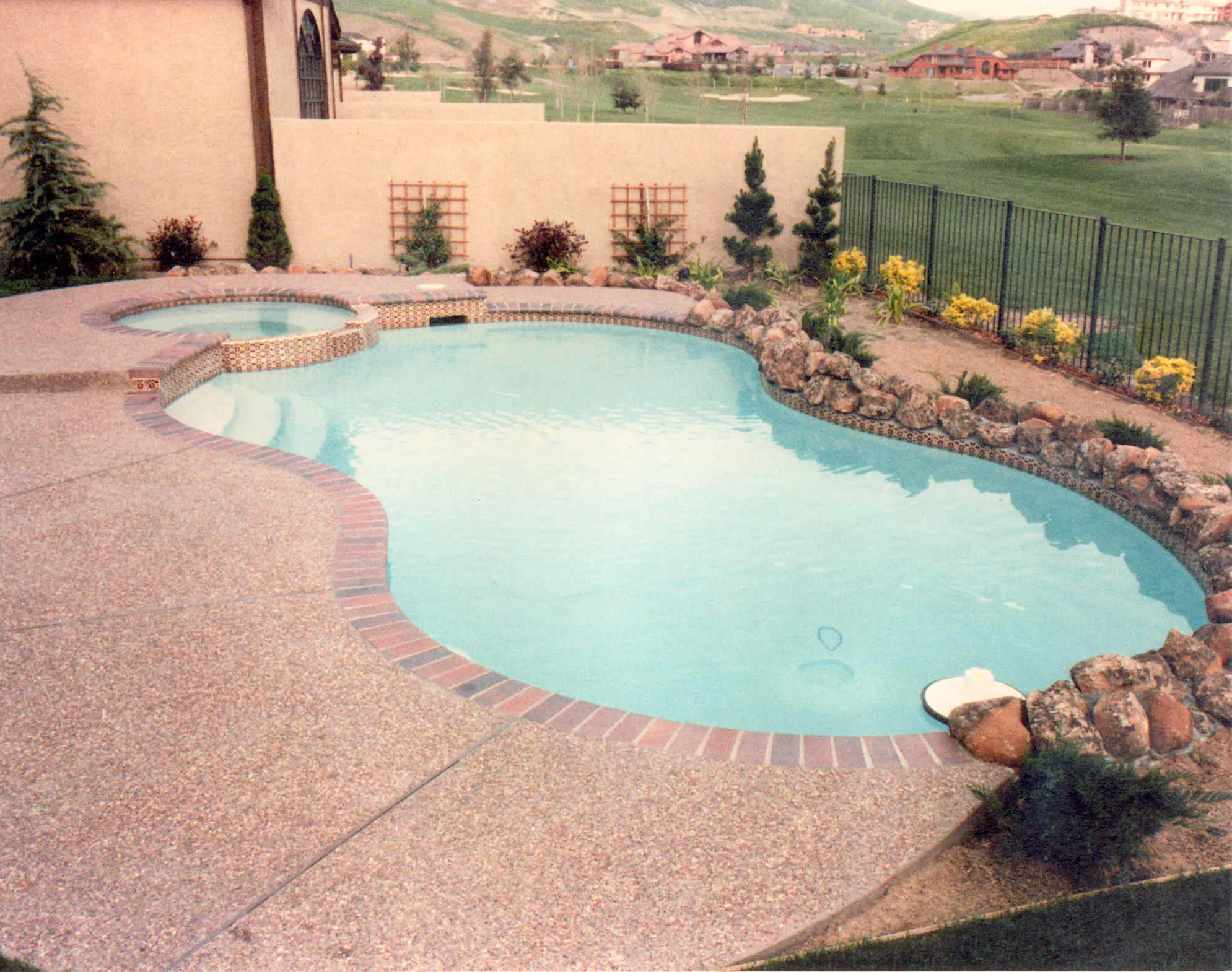Picture of  A serene backyard pool, embraced by carefully arranged rocks and lush landscaping, exemplifies Paradigm Concrete & Construction, Inc.'s commitment to quality outcomes. Recognized for expertise and quality, the company turns outdoor visions into reality. Copyright ©2025 Diamond Certified Resource.

 - Paradigm Concrete & Construction, Inc.