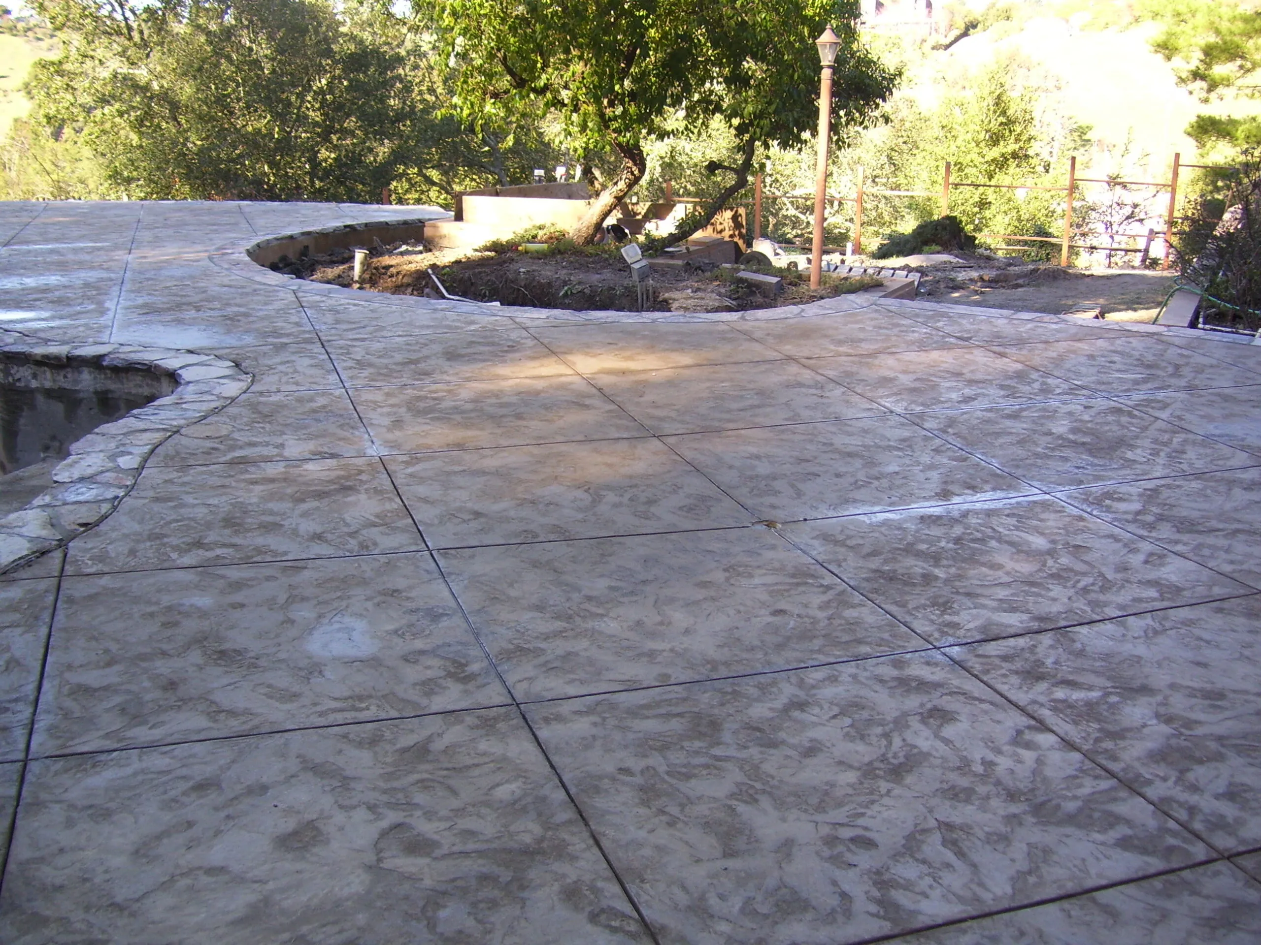 Picture of  Amidst a peaceful, sunlit landscape, Paradigm Concrete & Construction, Inc. has crafted a beautifully textured concrete patio, showcasing their focus on quality outcomes. Recognized for expertise and quality, the company transforms outdoor spaces with precision and care. Copyright ©2025 Diamond Certified Resource.

 - Paradigm Concrete & Construction, Inc.