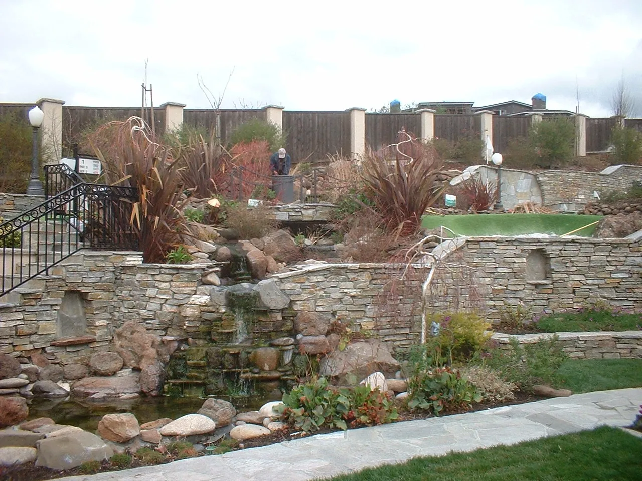 Picture of  Amidst a meticulously designed stone garden, a serene waterfall trickles down, embodying Paradigm Concrete & Construction, Inc.'s dedication to quality outcomes. Recognized for expertise and quality, this tranquil landscape showcases the company's craftsmanship and commitment to excellence. Copyright ©2025 Diamond Certified Resource.

 - Paradigm Concrete & Construction, Inc.