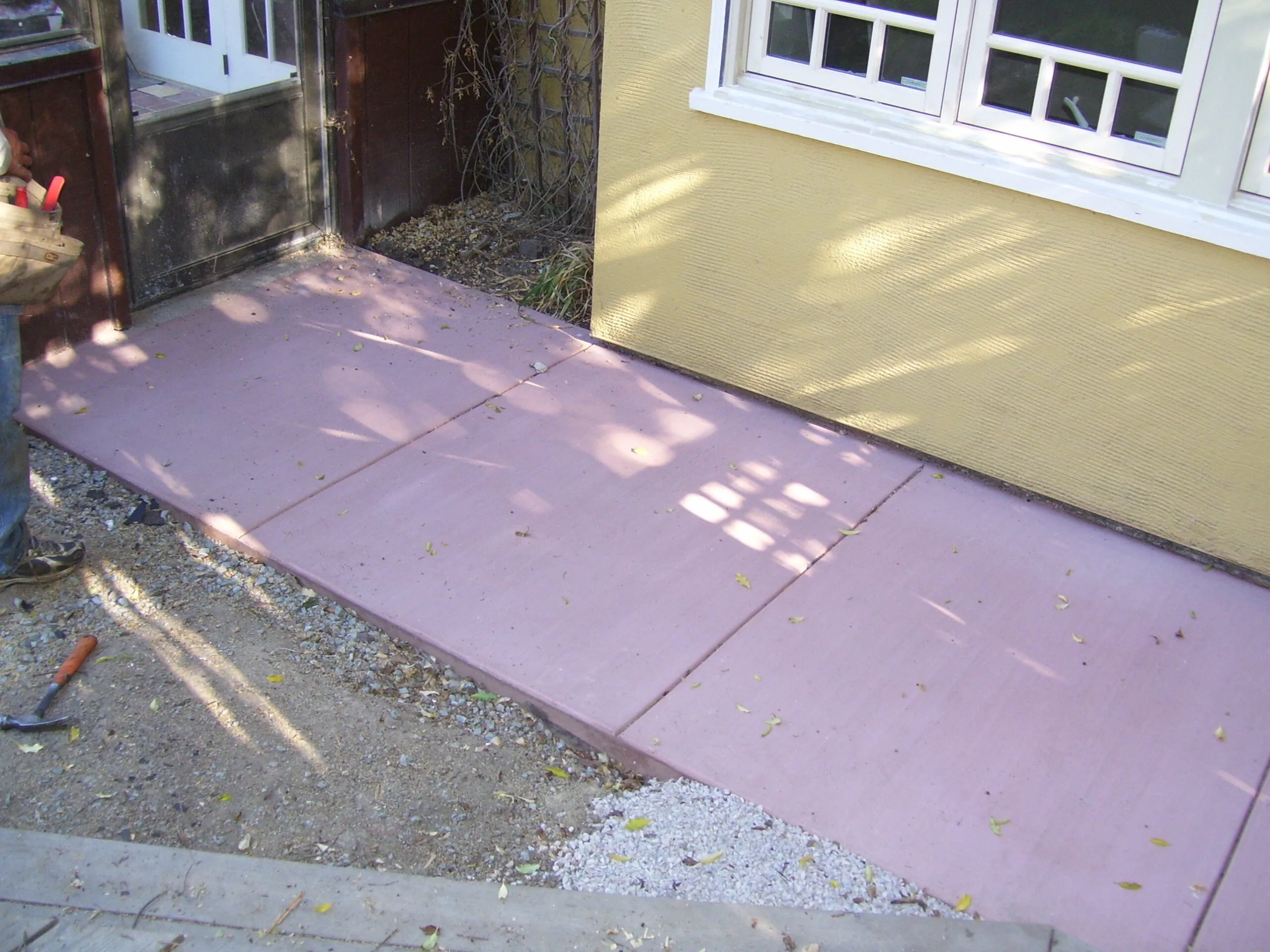 Picture of  A newly laid section of pink concrete walkway leads to a sunlit entrance, showcasing Paradigm Concrete & Construction, Inc.'s focus on quality outcomes. Copyright ©2025 Diamond Certified Resource.

 - Paradigm Concrete & Construction, Inc.