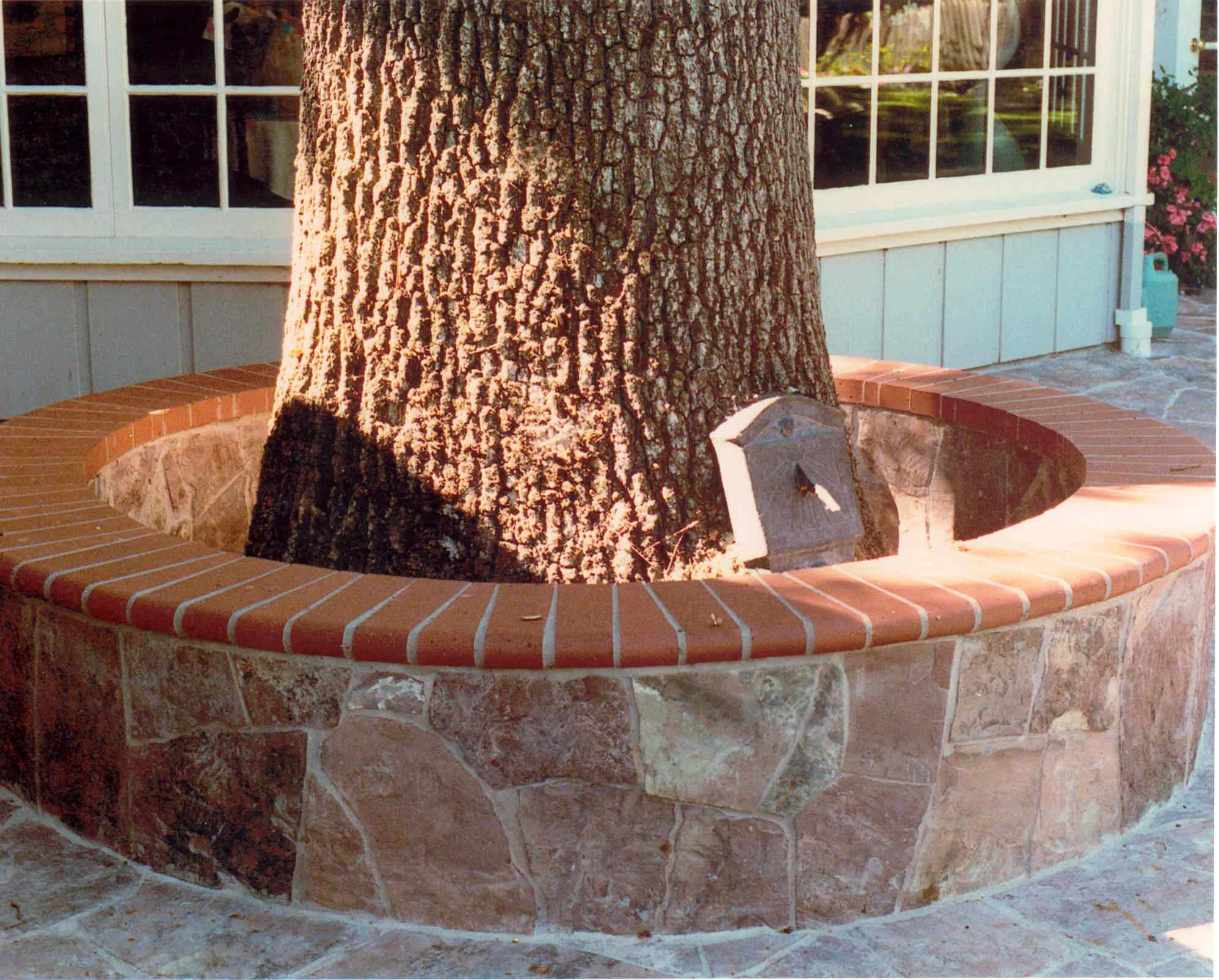 Picture of  Paradigm Concrete & Construction, Inc. demonstrates its craftsmanship with a custom brick and stone planter encircling a robust tree, highlighting their focus on quality outcomes. Copyright ©2025 Diamond Certified Resource.

 - Paradigm Concrete & Construction, Inc.