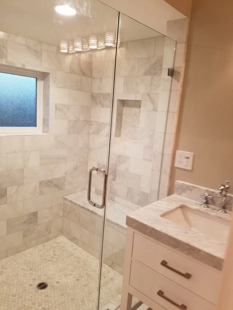 Picture of  A Ramos Construction, Inc. showcases its expertise in quality bathroom remodels with this elegantly tiled shower, complete with glass enclosure and marble finishes, highlighting their focus on quality outcomes. Copyright ©2025 Diamond Certified Resource.

 - A Ramos Construction, Inc.