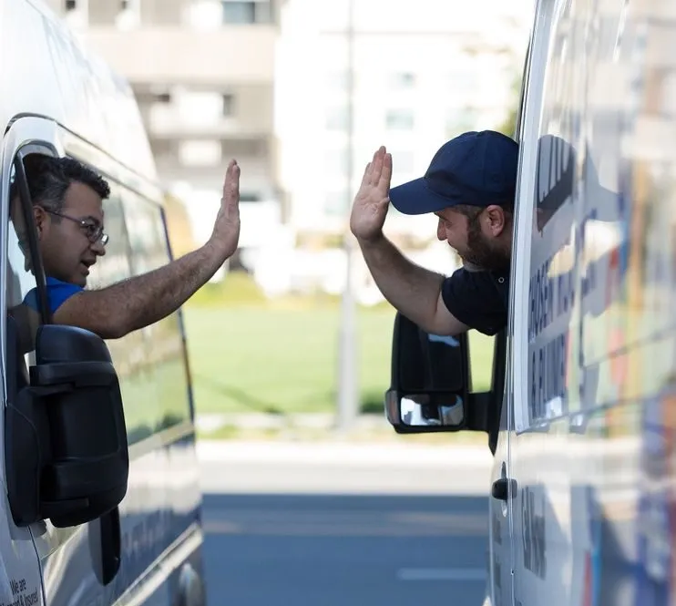 Picture of In a moment of camaraderie, two Chosen Rooter & Plumbing, Inc. team members share a friendly high-five from their service vans, embodying the company's commitment to teamwork and high customer satisfaction ratings. This connection reflects the supportive culture that drives quality outcomes in every project. Copyright ©2025 Diamond Certified Resource - Chosen Rooter & Plumbing, Inc.