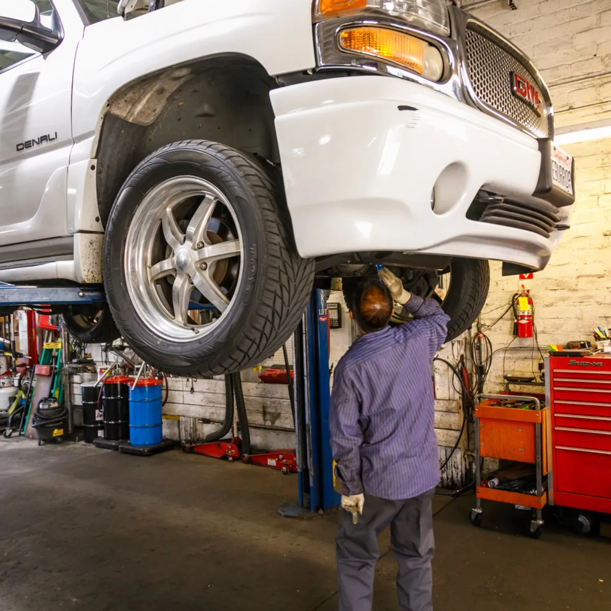 Picture of In the heart of Dana Meyer Auto Care, a technician meticulously inspects a vehicle suspended on a lift, embodying the company's focus on quality outcomes. This commitment to high standards is why the company consistently achieved a Highest in Quality rating. Copyright ©2025 Diamond Certified Resource - Dana Meyer Auto Care