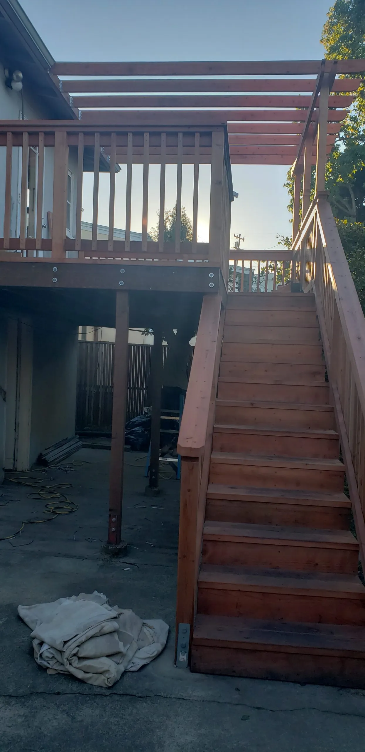 Picture of A Ramos Construction, Inc. completes a robust wooden staircase and deck under a serene evening sky, highlighting their commitment to quality outcomes. The structure stands testament to the companyâ€™s recognition for expertise and quality. Copyright ©2025 Diamond Certified Resource

 - A Ramos Construction, Inc.