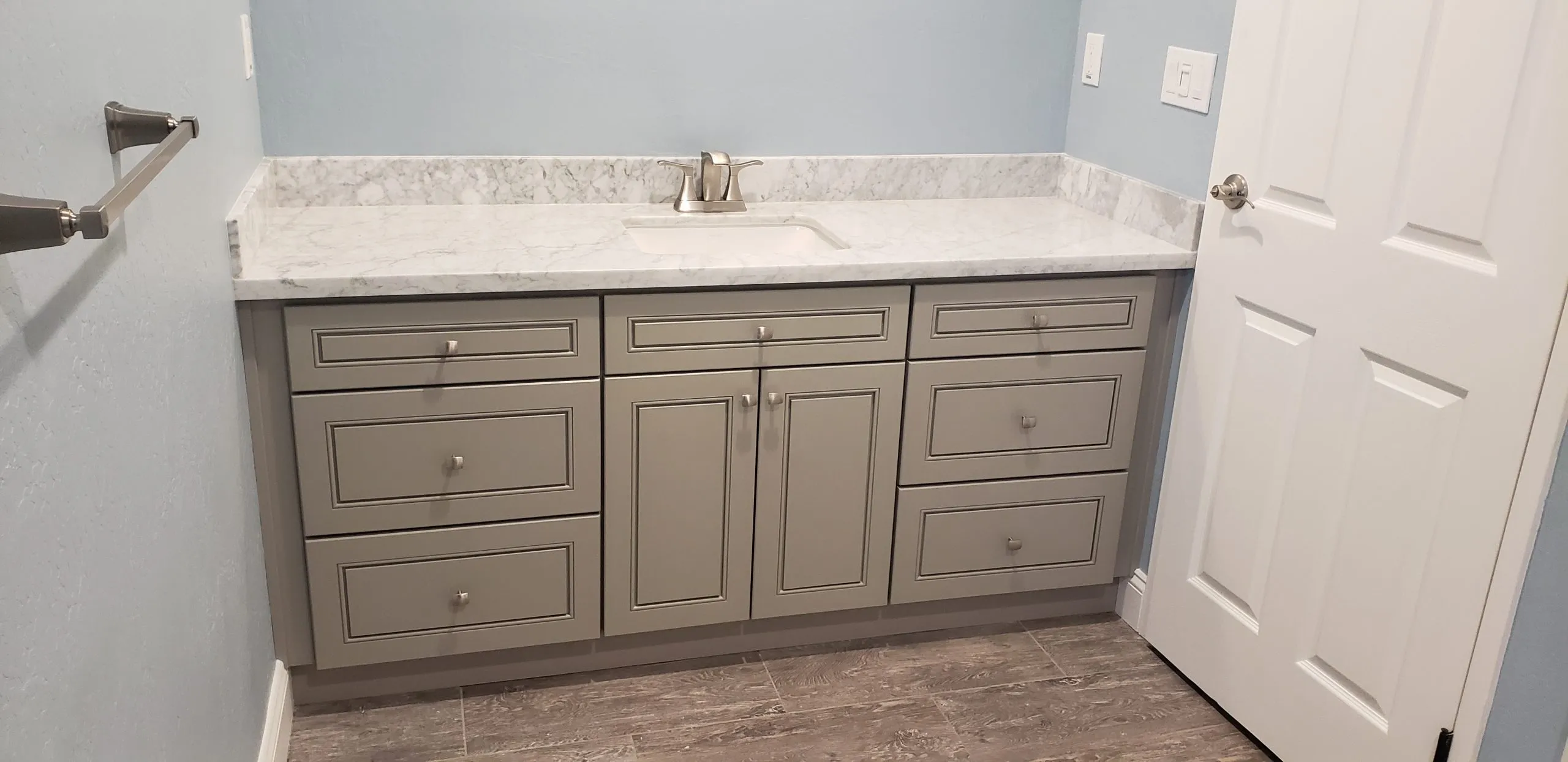 Picture of In a serene setting of pastel blue walls, A Ramos Construction, Inc. showcases its commitment to quality outcomes with this elegant bathroom vanity, earning high customer satisfaction ratings. Copyright ©2025 Diamond Certified Resource. - A Ramos Construction, Inc.