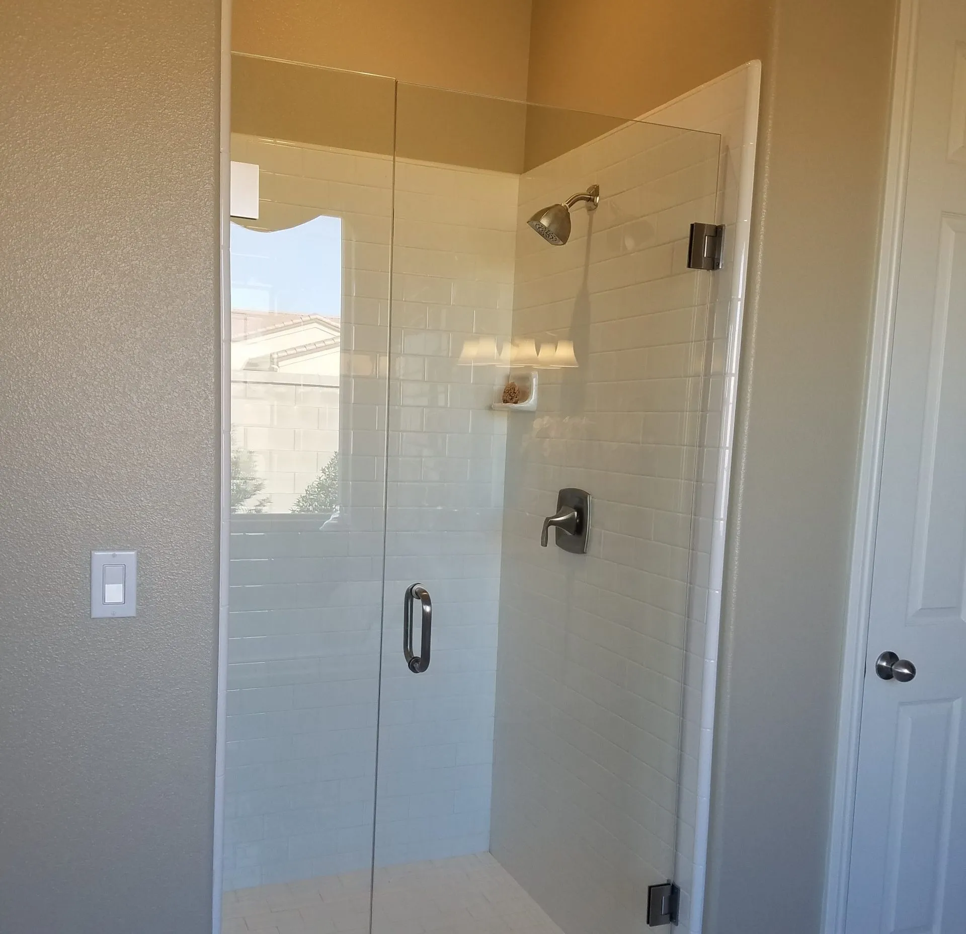 Picture of  A Ramos Construction, Inc. showcases a pristine bathroom remodel featuring sleek glass shower doors and clean, white tiling. This reflects their commitment to quality outcomes. Copyright ©2025 Diamond Certified Resource.

 - A Ramos Construction, Inc.