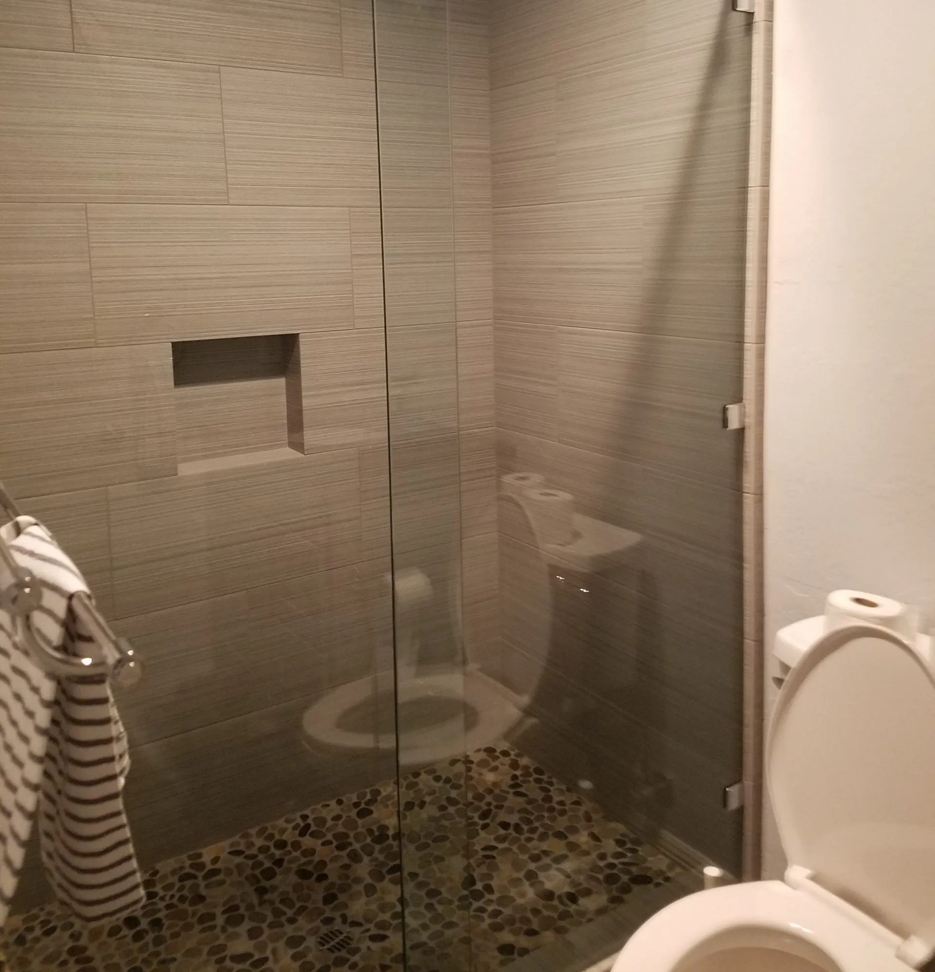 Picture of  In a serene bathroom setting, A Ramos Construction, Inc. showcases its expertise through the seamless integration of natural stone flooring and sleek glass enclosures. Recognized for expertise and quality, they consistently achieve the highest ratings. Copyright ©2025 Diamond Certified Resource.

 - A Ramos Construction, Inc.