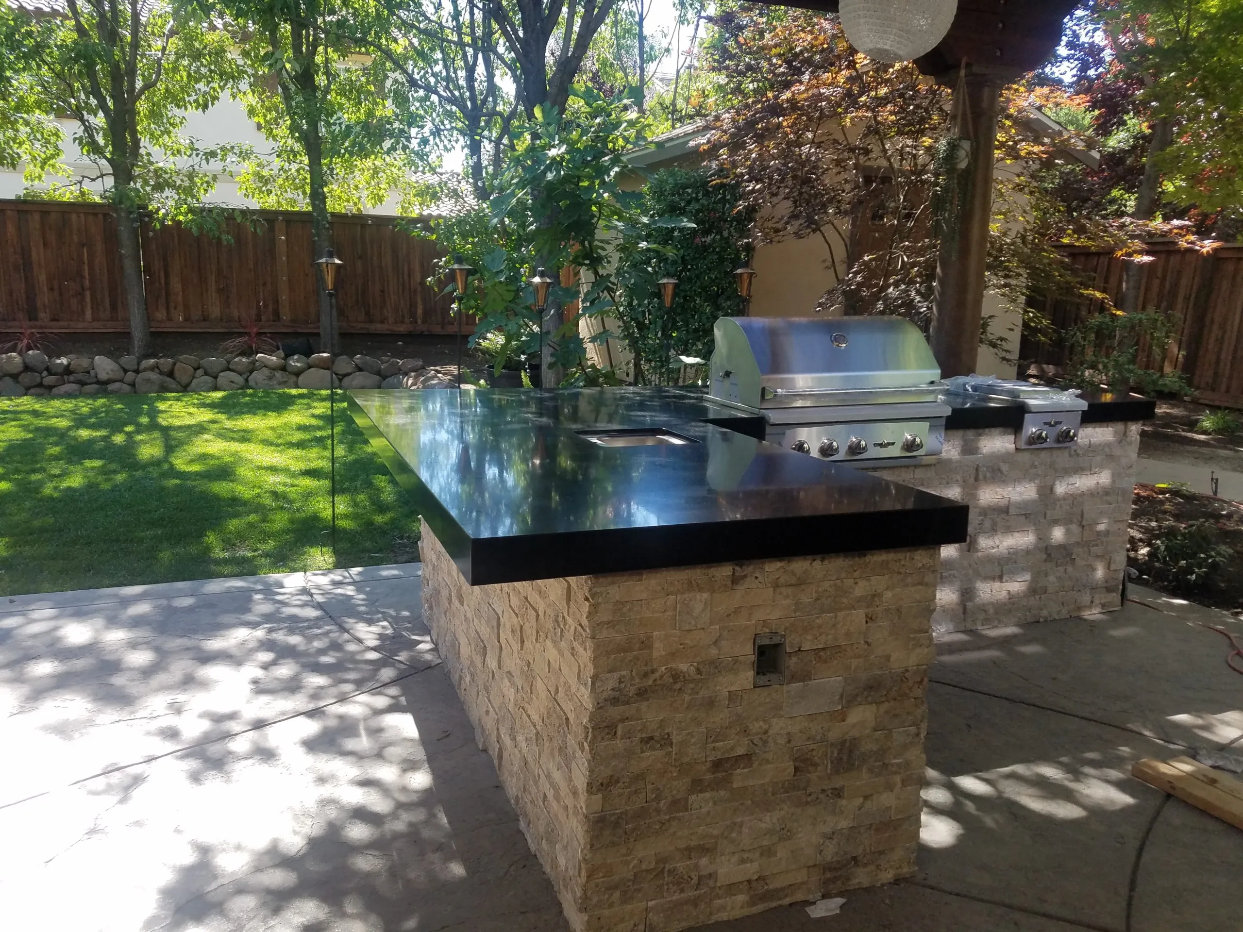Picture of  Under the dappled shade, a meticulously crafted outdoor kitchen stands ready, its stonework reflecting A Ramos Construction, Inc.'s unwavering focus on quality outcomes. This serene setting showcases their top-rated workmanship. Copyright ©2025 Diamond Certified Resource.

 - A Ramos Construction, Inc.