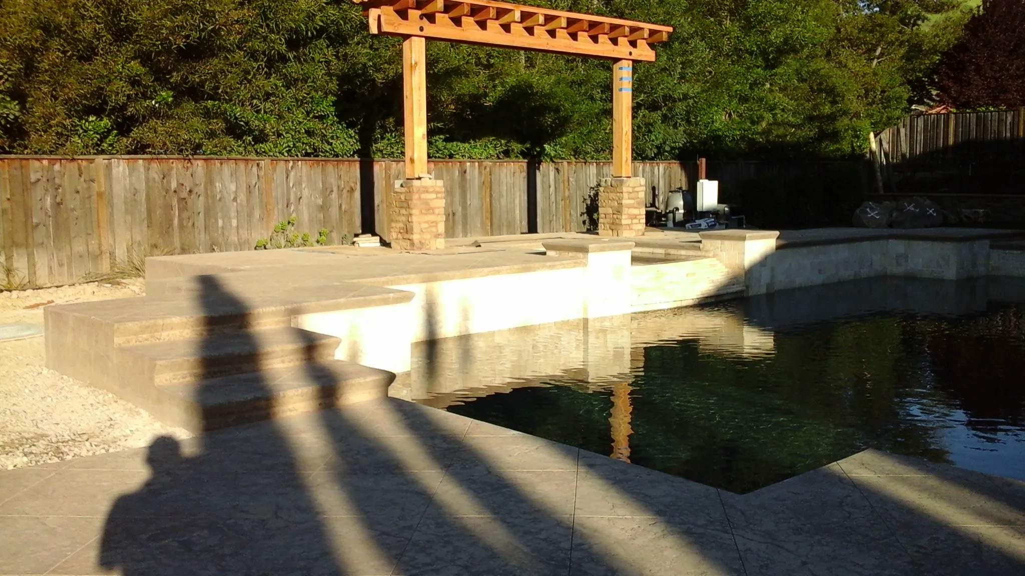 Picture of  Sunlit shadows stretch across a newly built poolside patio, where A Ramos Construction, Inc. has created an inviting outdoor space, showcasing their commitment to quality outcomes. Copyright ©2025 Diamond Certified Resource.

 - A Ramos Construction, Inc.