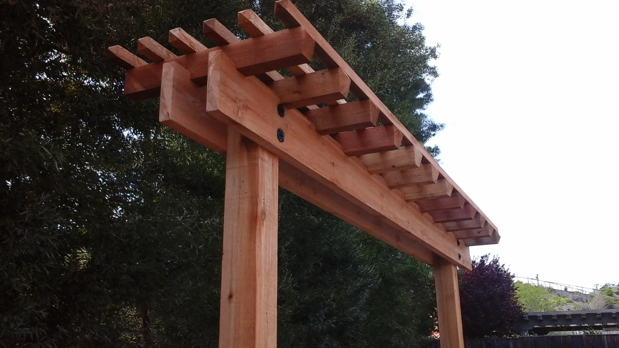 Picture of  Amidst a serene backdrop, a meticulously crafted wooden pergola stands as a testament to A Ramos Construction, Inc.'s dedication to quality outcomes. Recognized for expertise and quality, the company’s attention to detail shines through in each joint and beam. Copyright ©2025 Diamond Certified Resource.

 - A Ramos Construction, Inc.