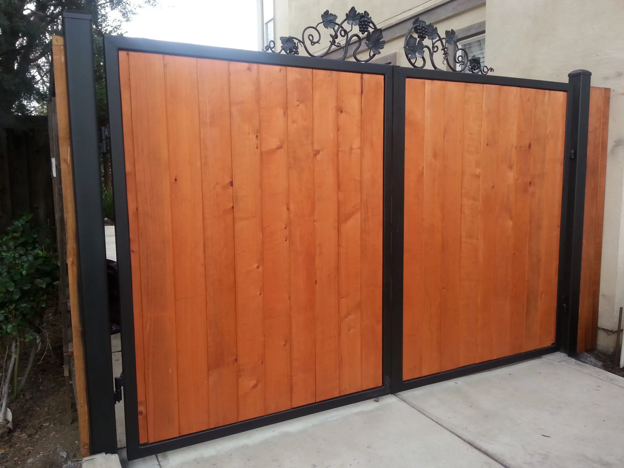 Picture of  A Ramos Construction, Inc. showcases its commitment to quality outcomes with a meticulously crafted wooden gate featuring a black metal frame and ornate detailing. This attention to detail highlights why the company is recognized for expertise and quality. Copyright ©2025 Diamond Certified Resource.

 - A Ramos Construction, Inc.