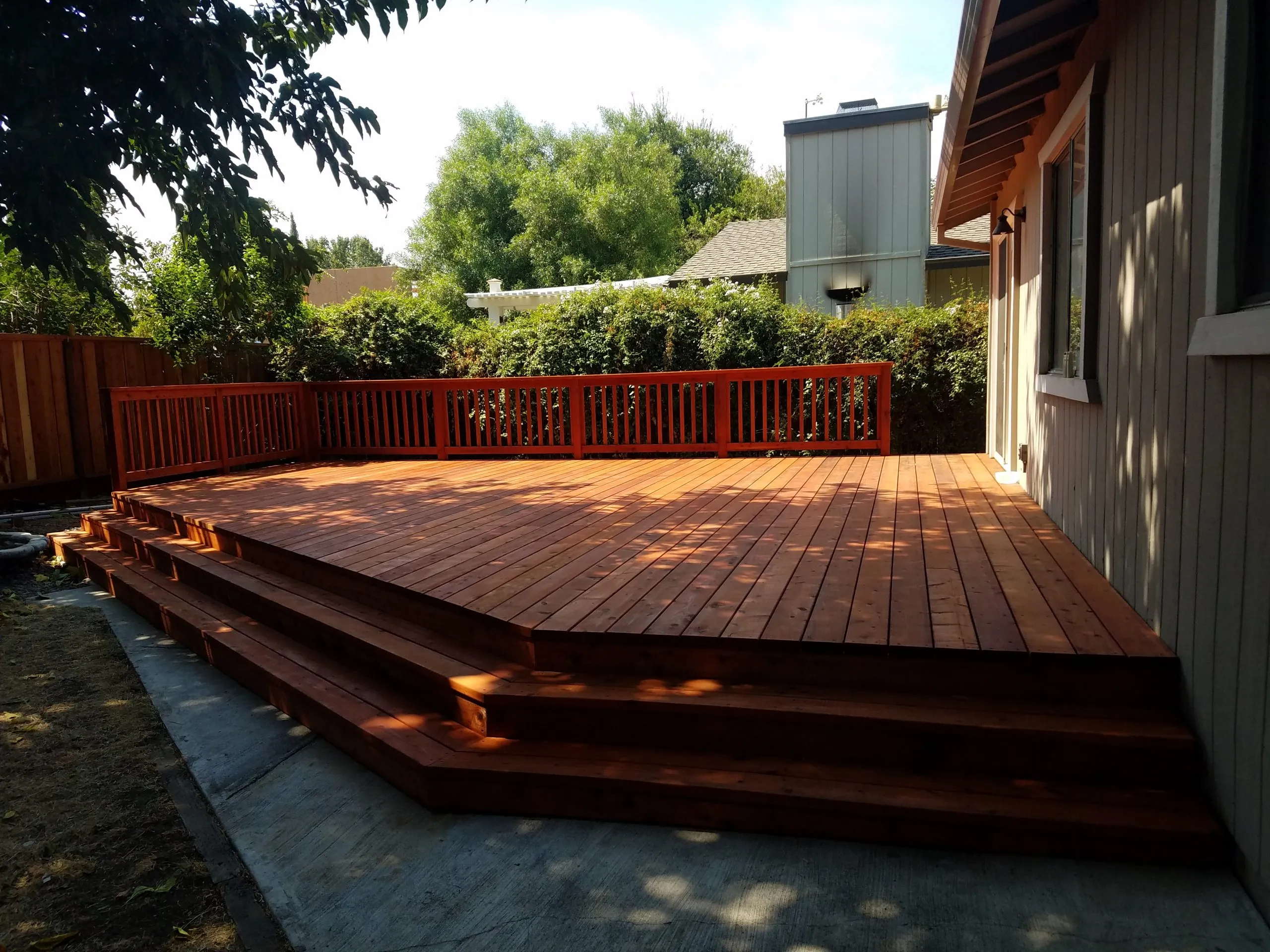 Picture of A newly constructed wooden deck by A Ramos Construction, Inc. blends seamlessly into a sunlit backyard, highlighting the company's focus on quality outcomes. Copyright ©2025 Diamond Certified Resource

 - A Ramos Construction, Inc.
