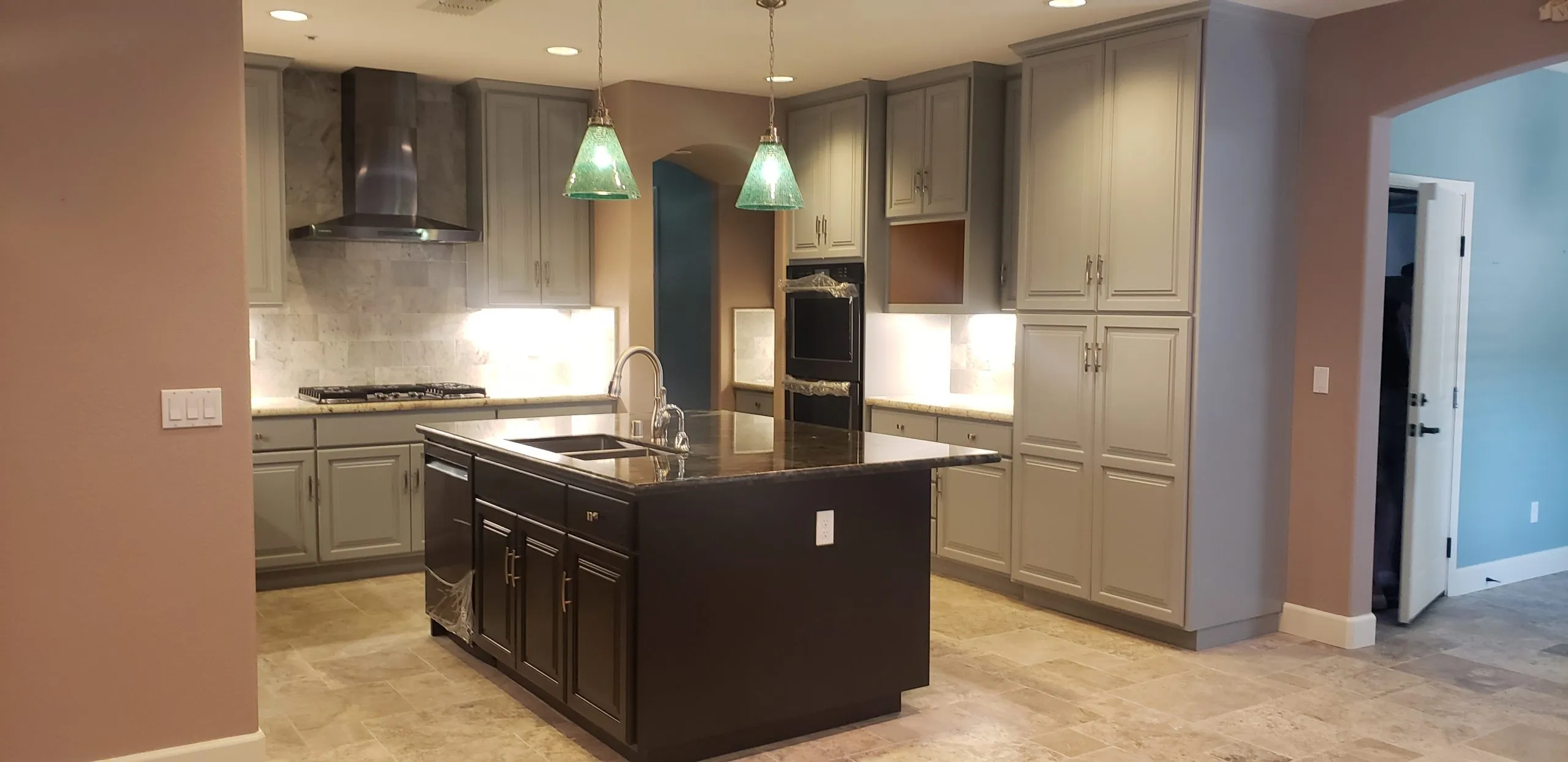 Picture of An elegant kitchen showcases modern lighting, refined cabinetry, and a central island, hinting at a seamless blend of function and style. A Ramos Construction, Inc. ensures quality outcomes with every detail. Copyright ©2025 Diamond Certified Resource

 - A Ramos Construction, Inc.