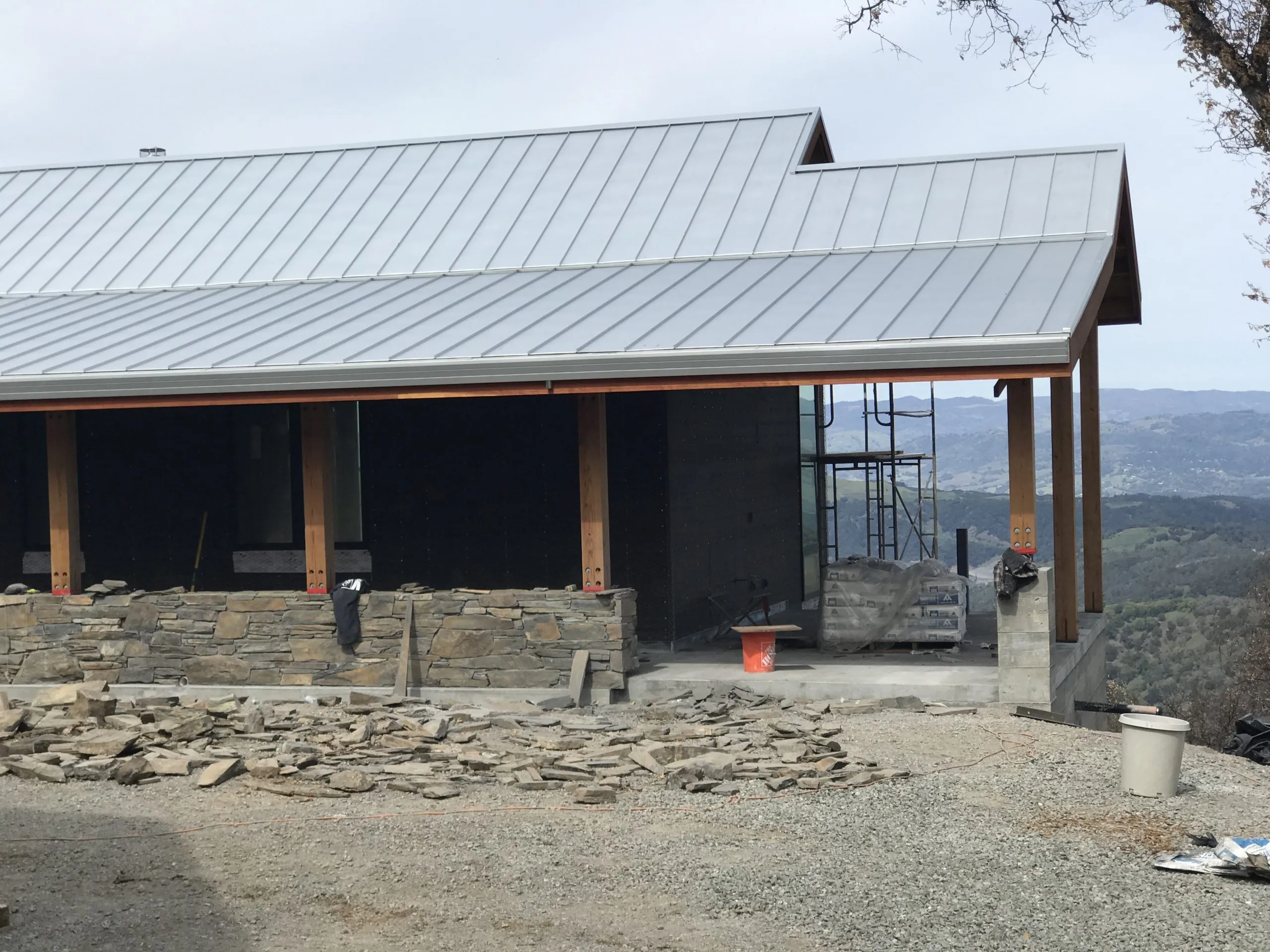 Picture of A sleek metal roof crowns a hillside structure, showcasing Crandall Roofing Inc.'s dedication to quality outcomes. With a commitment to excellence, they ensure high customer satisfaction in every project. Copyright ©2025 Diamond Certified Resource - Crandall Roofing Inc.