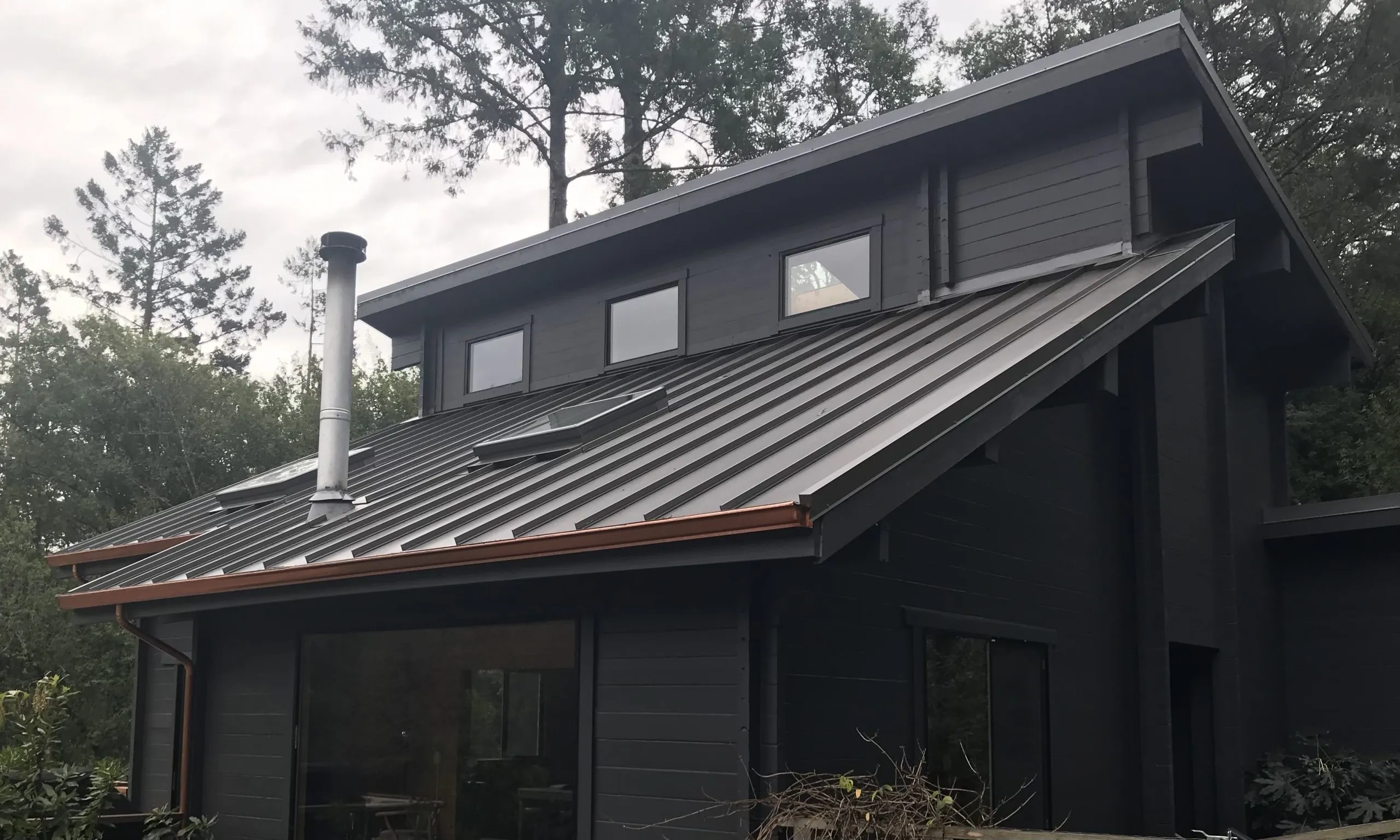 Picture of The sleek, modern lines of this newly installed metal roof by Crandall Roofing Inc. not only enhance the home's aesthetic but also promise durability and protection. With a focus on quality outcomes, Crandall Roofing is recognized for expertise and quality, ensuring every project meets the highest standards. Copyright ©2025 Diamond Certified Resource - Crandall Roofing Inc.