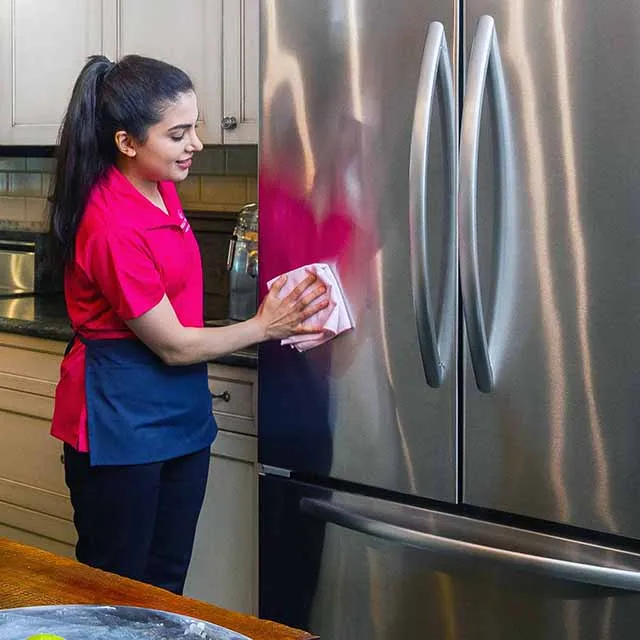 Picture of A dedicated team member from Molly Maid of S. Silicon Valley polishes a refrigerator, reflecting the company's commitment to quality outcomes. This attention to detail underscores their consistently high customer satisfaction ratings. Copyright ©2025 Diamond Certified Resource

 - Molly Maid of S. Silicon Valley