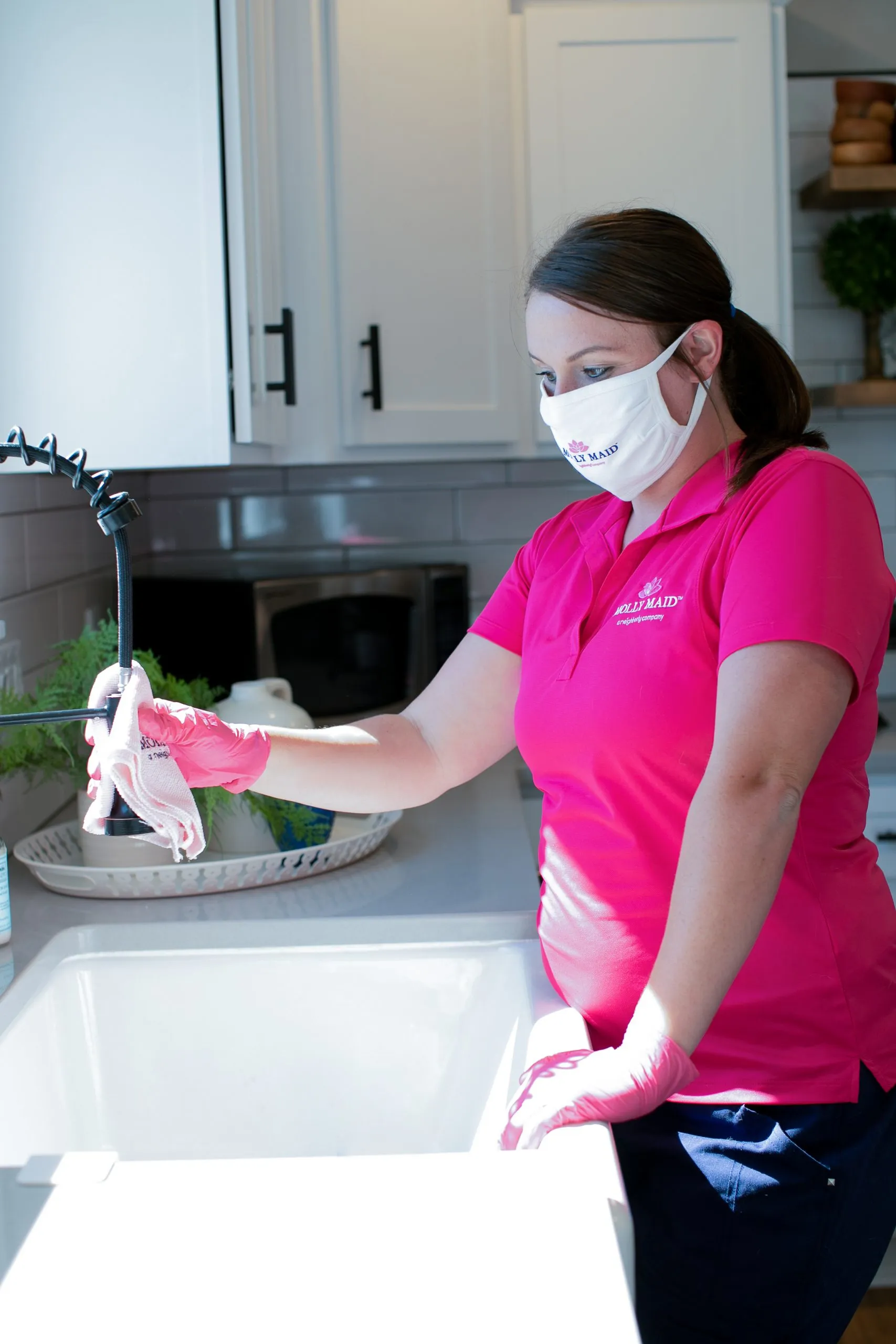 Picture of In a bright kitchen, a professional from Molly Maid of S. Silicon Valley ensures every fixture gleams, showcasing their attention to detail as a Diamond Certified company. Copyright ©2025 Diamond Certified Resource

 - Molly Maid of S. Silicon Valley