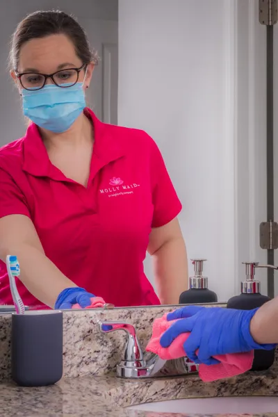 Picture of In a moment of precision, a Molly Maid of S. Silicon Valley team member attentively cleans a bathroom faucet, reflecting the companyâ€™s focus on quality outcomes. Copyright ©2025 Diamond Certified Resource

 - Molly Maid of S. Silicon Valley