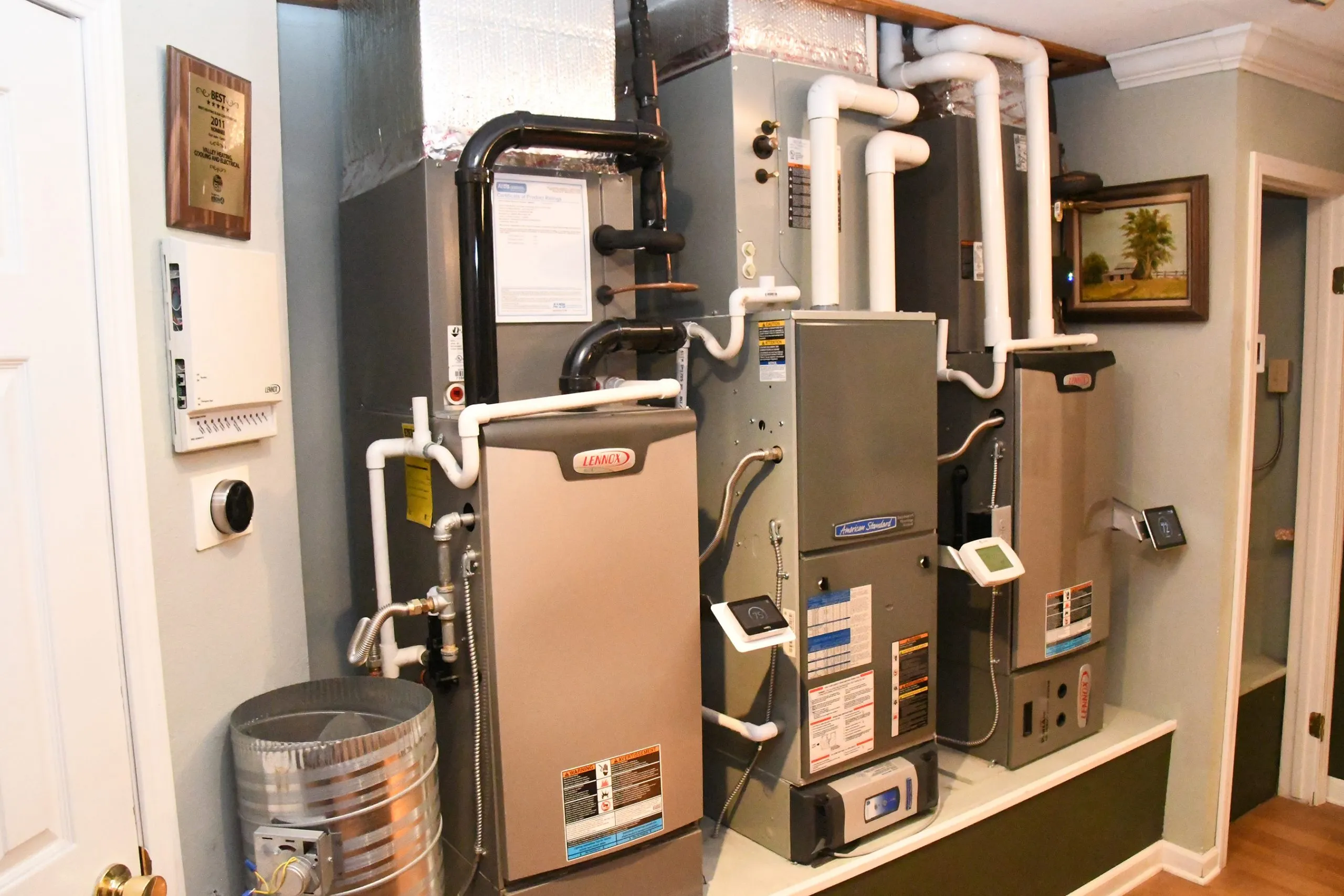 Neatly configured HVAC units with various ducts and controls in a residential setting, highlighting professional installation and setup. Neatly configured HVAC units with various ducts and controls in a residential setting, highlighting professional installation and setup.