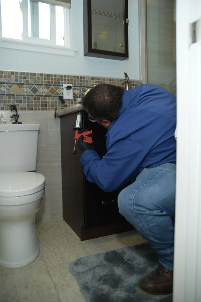 Picture of In a quiet bathroom space, a professional from Presto Pest Control, Inc. meticulously seals cabinet edges, reflecting the company’s focus on quality outcomes. Their expertise in creating pest-free environments underscores their high customer satisfaction ratings. Copyright ©2025 Diamond Certified Resource. - Presto Pest Control, Inc.