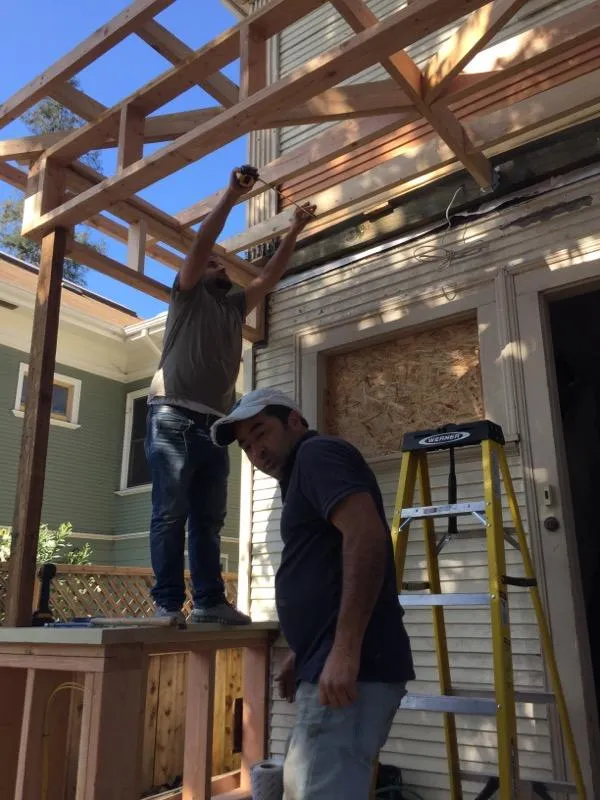 Picture of Amidst the construction of a new porch, the focus is on precision and teamwork as craftsmen carefully align beams. Green Living Builders LLC showcases their expertise with this project, consistently achieving a Highest in Quality rating. Copyright ©2025 Diamond Certified Resource

 - Green Living Builders LLC