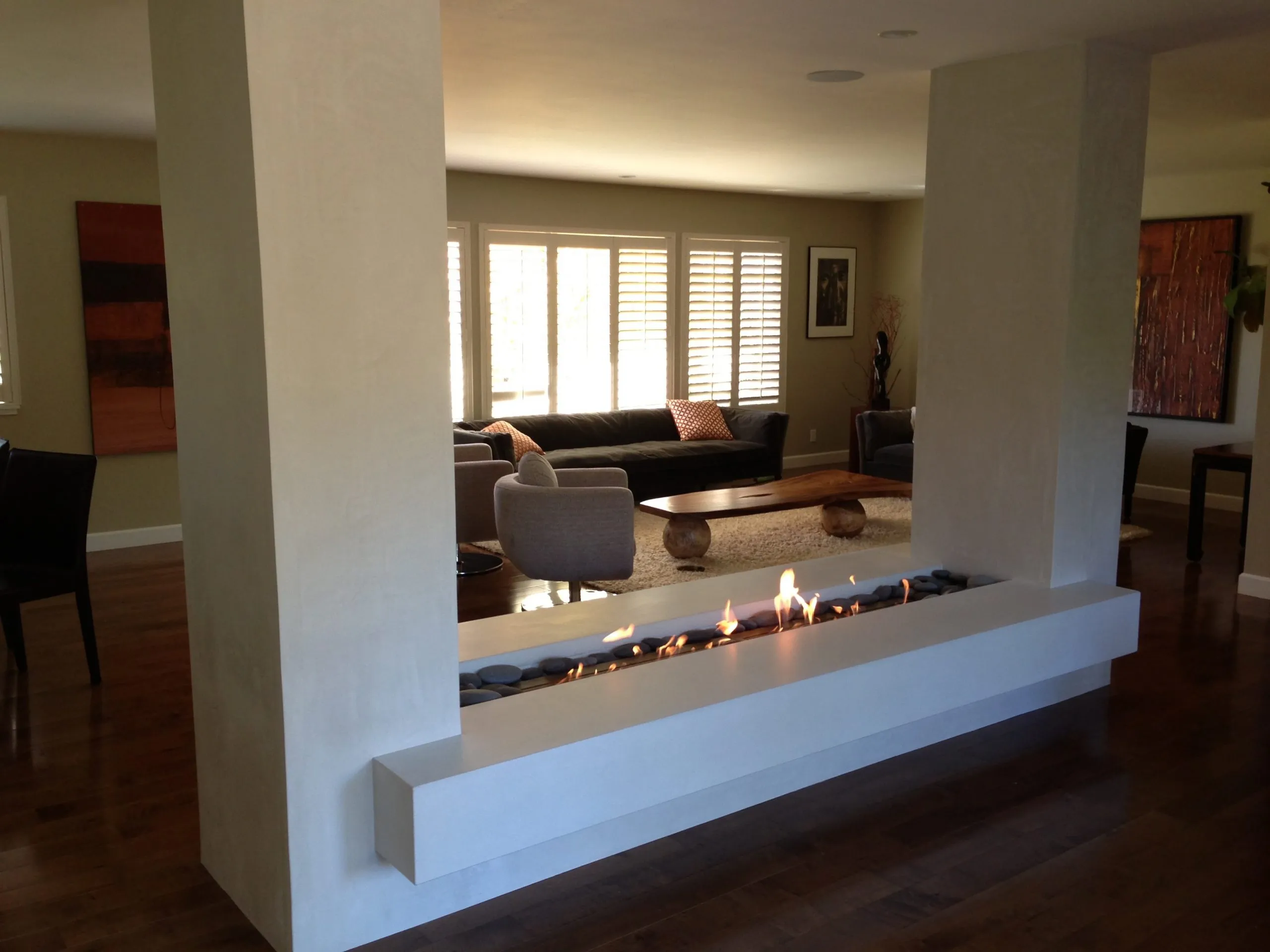 Picture of A sleek, modern fireplace elegantly divides a living space, showcasing Green Living Builders LLC's focus on quality outcomes. The minimalist design enhances the room's aesthetics while providing warmth. Experience their expertise in creating both functional and beautiful spaces. Copyright ©2025 Diamond Certified Resource

 - Green Living Builders LLC