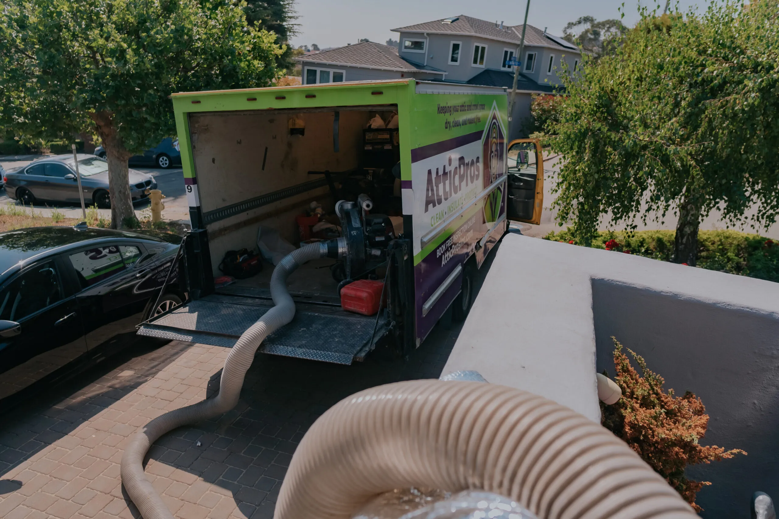 Picture of A lone hose extends from an Attic Pros truck, quietly transforming spaces with precisionâ€”an embodiment of their focus on quality outcomes. Copyright ©2025 Diamond Certified Resource - Attic Pros