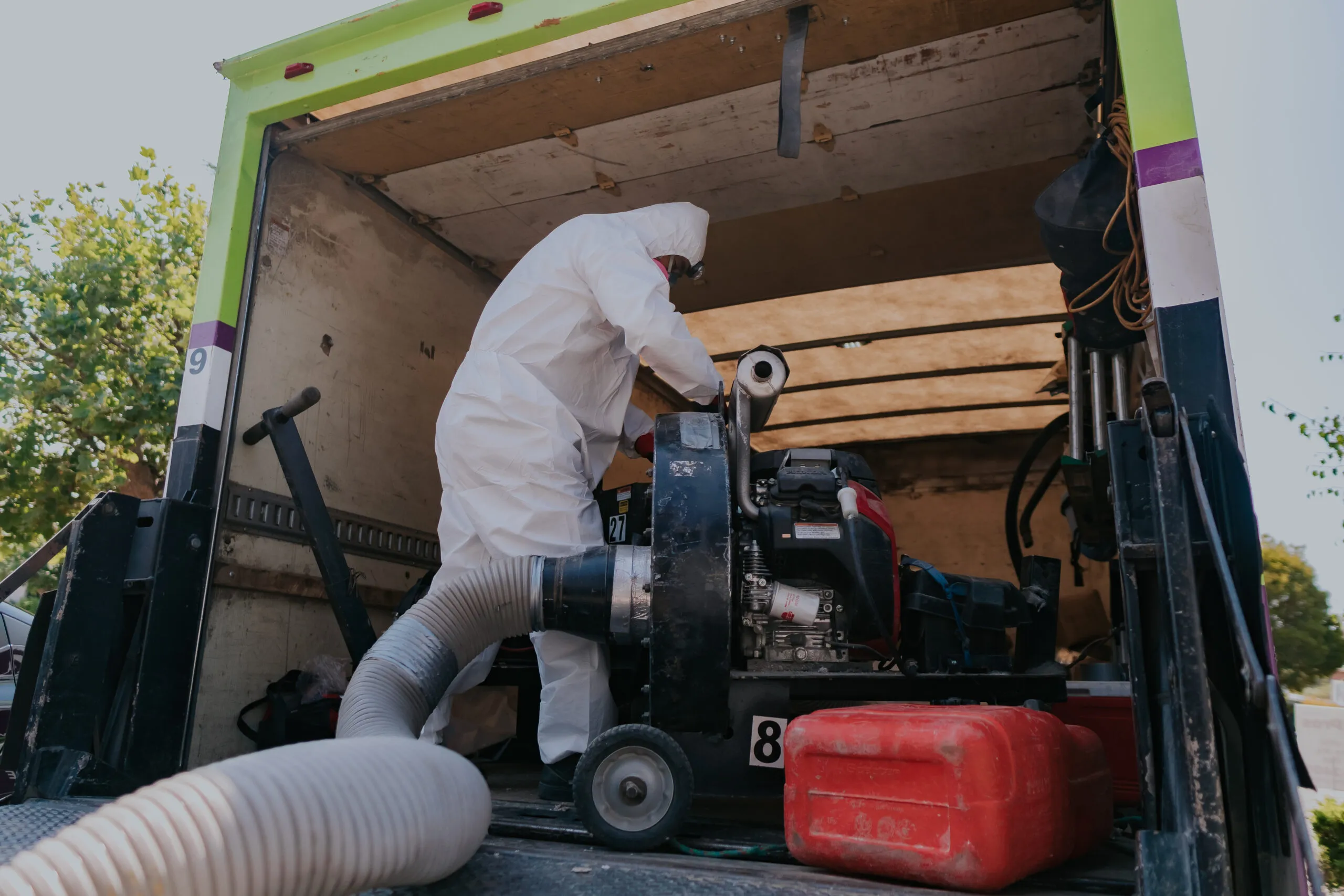 Picture of A technician in protective gear operates specialized equipment inside a truck, exemplifying Attic Pros' commitment to high-quality service. The company consistently achieves a Highest in Quality rating. Copyright ©2025 Diamond Certified Resource

 - Attic Pros