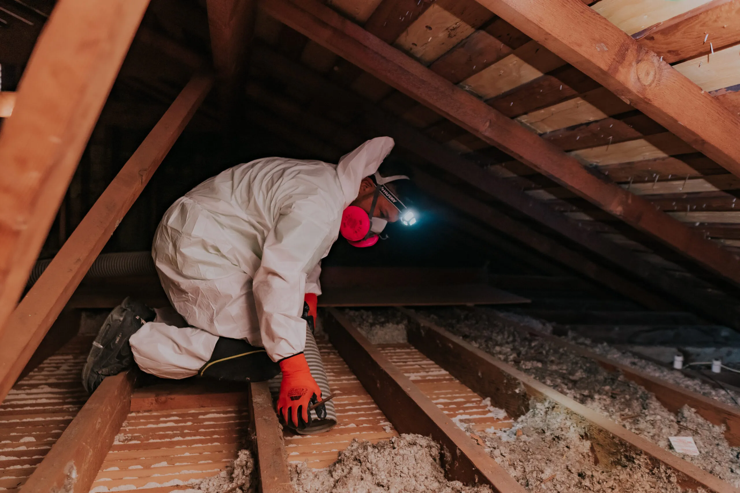 Picture of A technician from Attic Pros navigates an attic space, equipped with protective gear and focused precision. Attic Pros, recognized for expertise and quality, ensures high customer satisfaction. Copyright ©2025 Diamond Certified Resource

 - Attic Pros