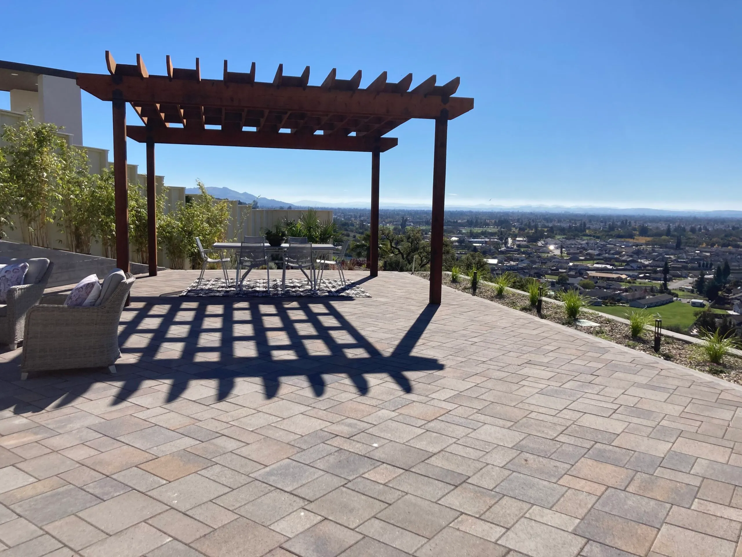 Picture of Under the clear blue sky, a serene patio with a pergola overlooks the city, showcasing The Legacy Paver Group's commitment to quality outcomes. Recognized for expertise, they transform spaces into tranquil retreats. Copyright ©2025 Diamond Certified Resource

 - The Legacy Paver Group