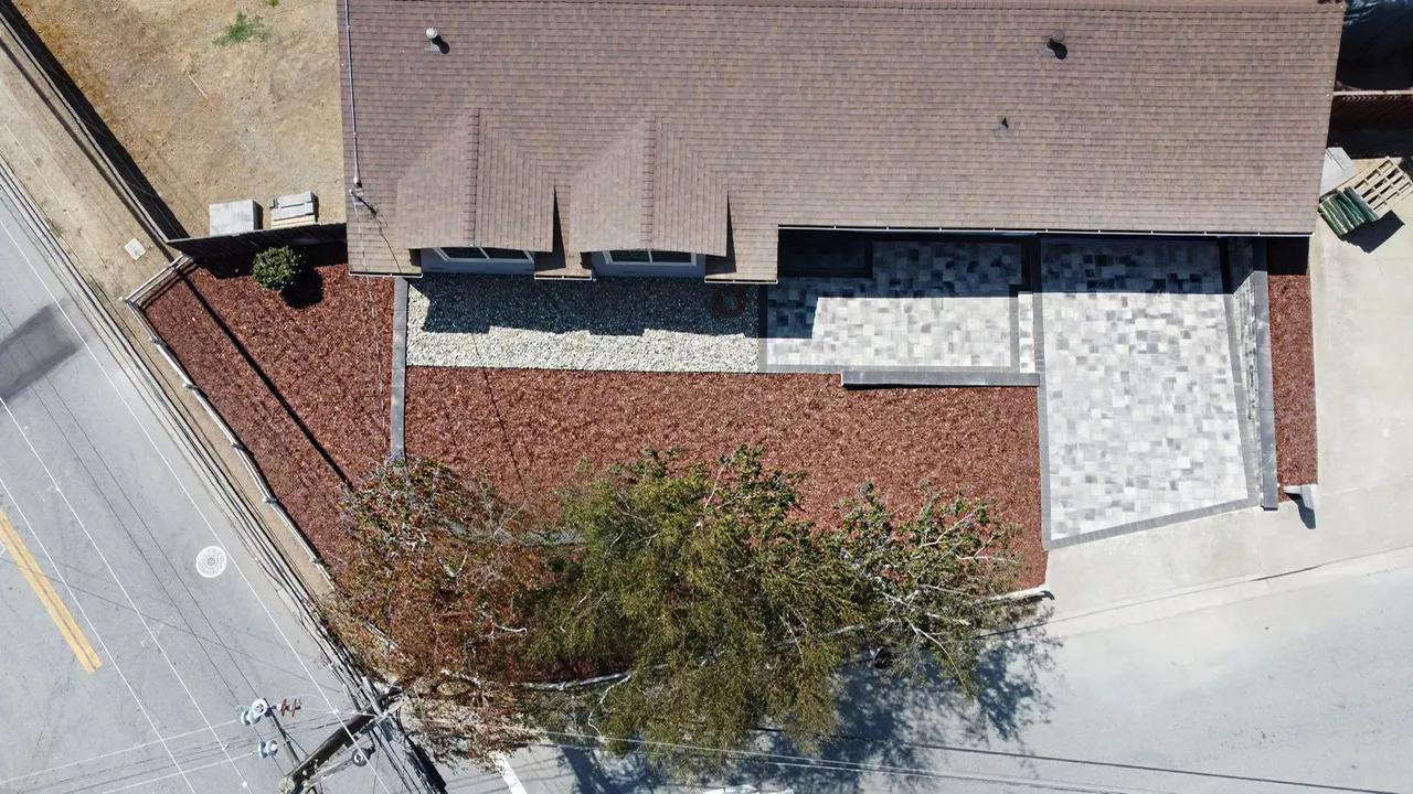 Picture of An aerial view captures the precision of Unique Paversâ€™ work, blending geometric stonework with natural elements. The harmonious design exemplifies their focus on quality outcomes, enhancing curb appeal with expert craftsmanship. Copyright ©2025 Diamond Certified Resource

 - Unique Pavers