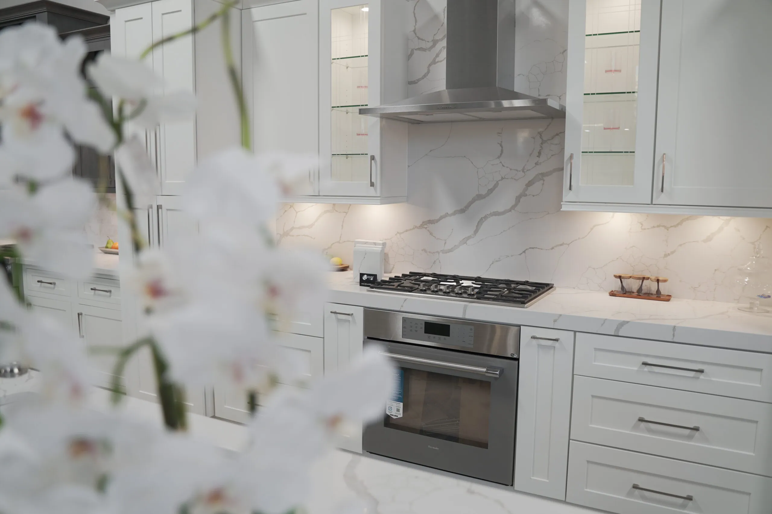 Picture of A sleek kitchen, showcasing Today's Kitchen & Bath's focus on quality outcomes through elegant design and immaculate craftsmanship. The soft glow from under-cabinet lighting highlights the pristine finish of the countertops. Copyright ©2025 Diamond Certified Resource

 - Today's Kitchen & Bath