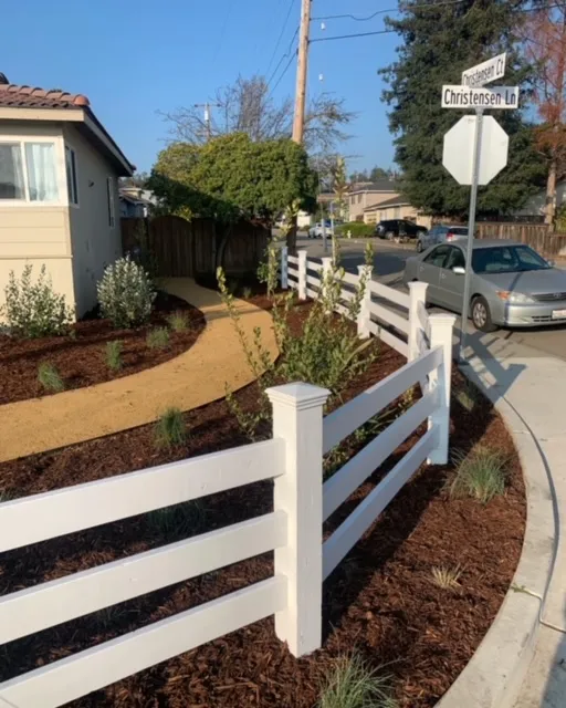 Picture of A thoughtfully landscaped corner with a pristine white fence and newly planted shrubs hints at ARP Hardscapeâ€™s focus on quality outcomes. This tranquil scene on Christensen Ln reflects the companyâ€™s Diamond Certified expertise in crafting welcoming spaces. Copyright ©2025 Diamond Certified Resource

 - ARP Hardscape