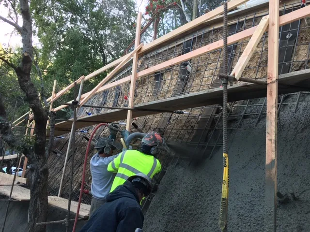 Picture of Amidst a serene backdrop of trees, AcuStruct workers expertly spray concrete onto a reinforced wall, illustrating their commitment to quality outcomes. As the team solidifies structures with precision, they underscore why the company consistently achieved a Highest in Quality rating. Copyright ©2025 Diamond Certified Resource

 - AcuStruct