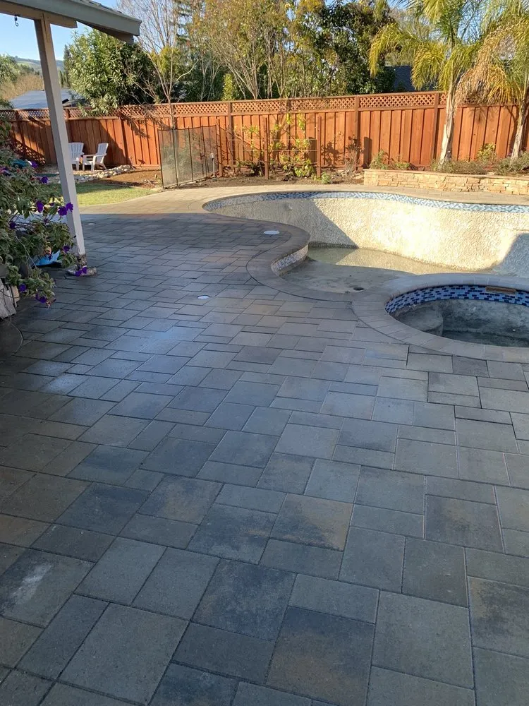 Picture of In this serene backyard, ARP Hardscape expertly transforms an empty poolside area with precision-laid pavers, reflecting their commitment to quality outcomes. Copyright ©2025 Diamond Certified Resource - ARP Hardscape