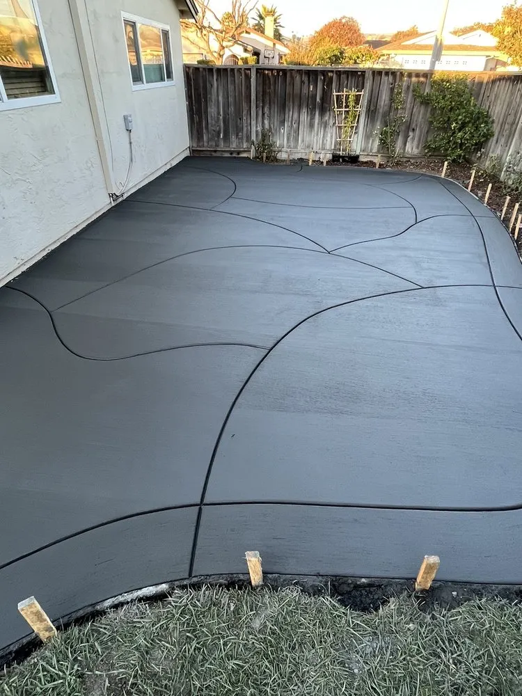 Picture of A newly laid, smooth concrete patio with elegant curves showcases ARP Hardscapeâ€™s dedication to quality outcomes. This artistic touch reflects their consistently high customer satisfaction ratings. Copyright ©2025 Diamond Certified Resource

 - ARP Hardscape